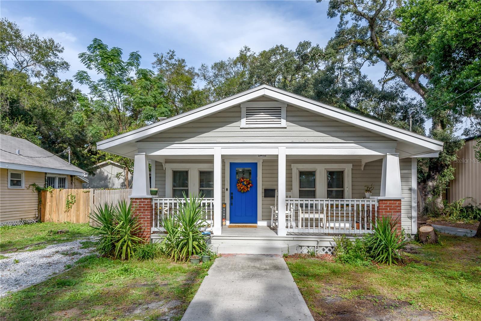 Beautifully renovated 1918 Craftsman bungalow in Old Seminole Heights, offering the perfect blend of character and modern convenience. An oversized front porch welcomes you into a sun-filled, open living space with a wood-mantel fireplace and updated flooring throughout. The kitchen features quartz countertops, stainless steel appliances, shaker cabinetry, and navy subway tile with peninsula seating.
Enjoy a desirable split floorplan: two guest bedrooms and a full bath on one side, with a private primary suite on the opposite end featuring a walk-in closet, a spa-like en-suite bath with hex tile shower, and direct access to the backyard. The fully fenced yard includes a paved seating area and a storage shed with electricity — offering endless possibilities as a workshop, studio, or home gym.
Walking distance to Cleveland Elementary, with easy access to I-275, USF, and Downtown Tampa. A must-see!