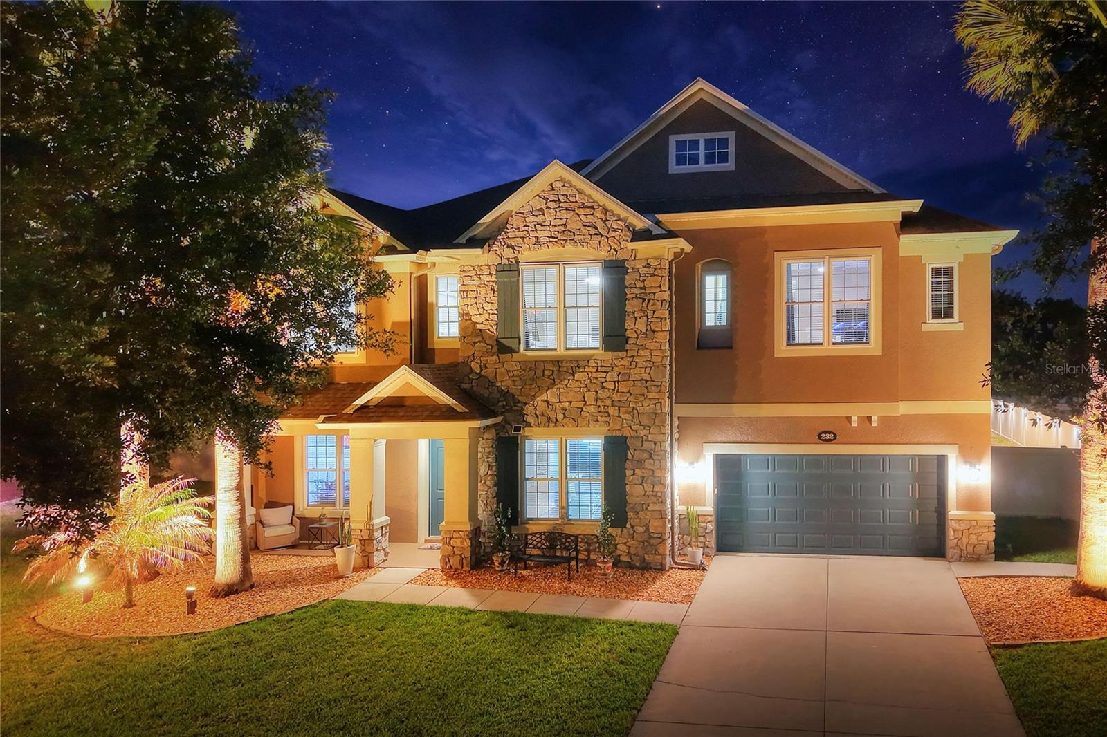 Welcome to 232 Magneta Loop, a beautifully upgraded 5-br, 3.5-ba pool home in the gated Estates of Auburndale community. With 5,224 sq ft of living space on a PVC-fenced lot, this impressive two-story residence features exceptional space, technology-enabled upgrades, energy-efficiency improvements, and resort-style outdoor living. Built in 2014, the home makes a strong first impression with its stone-accent exterior, 9-ft ceilings, 8-ft interior doors, generous formal and casual living areas, a private office/flex room, an expansive upstairs loft/game room, a full-size home gym, custom built-in walk-in closets, and a wet bar with a dual-temperature wine and beverage cooler, all designed to support comfortable everyday living, entertaining, remote work, fitness, and flexible use.

Over the last 3 years, the home has been thoughtfully upgraded inside and out with improvements that enhance comfort, efficiency, style, and modern connected-home living. Updates include fresh interior and exterior paint, energy-efficient vinyl windows throughout, an upgraded energy-efficient rear sliding glass door opening to the backyard and pool area, and custom blinds throughout for added privacy and light control. Technology features include Philips Hue full-color lighting inside and outside, app-enabled dimmers, energy-efficient motion-activated lighting in select areas, and Ethernet/CAT5 wiring throughout for streaming, work-from-home, connected-home, and networking needs.

Designed for both everyday living and entertaining, the kitchen features granite countertops, abundant cabinetry, a tile backsplash, a large breakfast bar, a coffee/tea bar, and Samsung Bespoke connected appliances, including a refrigerator, range, microwave, and dishwasher, with Samsung app connectivity. The spacious laundry room includes cabinetry, a utility sink, and a Samsung Bespoke washer and dryer with app connectivity. Additional upgrades include a whole-home surge protection system to guard against storm-related power surges, a water softener system, a lightweight aluminum accordion attic ladder, and ceiling fans.

Recent flooring upgrades include Bradstreet History Oak Anise luxury vinyl plank flooring, featuring a warm wood-look designer finish with pet-friendly, waterproof, low-maintenance durability. Exterior upgrades include custom rain gutters throughout the front and rear of the home, a B-hyve app-controlled irrigation system serving the front, back, and side yards, plus landscape lighting throughout the front, rear, and side yards for enhanced curb appeal, evening ambiance, and outdoor enjoyment.

Step outside to a private, screened outdoor retreat featuring a 5-year-old saltwater pool and spa with electric and solar heating, a covered lanai, landscape lighting, and outdoor dining and lounge areas, all designed for year-round Florida living. The deep tandem garage includes an EV charger, a camera-enabled opener with an exterior keypad, and oversized 4-car capacity, creating exceptional flexibility for multiple vehicles, storage, workshop use, or recreational equipment. Community amenities include a kiddie pool, pool, playground, clubhouse, basketball court, and a turtle preserve. Conveniently located near lakes, parks, shopping, dining, and major Central Florida routes, with a prime central location between the Tampa and Orlando airport areas for regional and out-of-state travel.