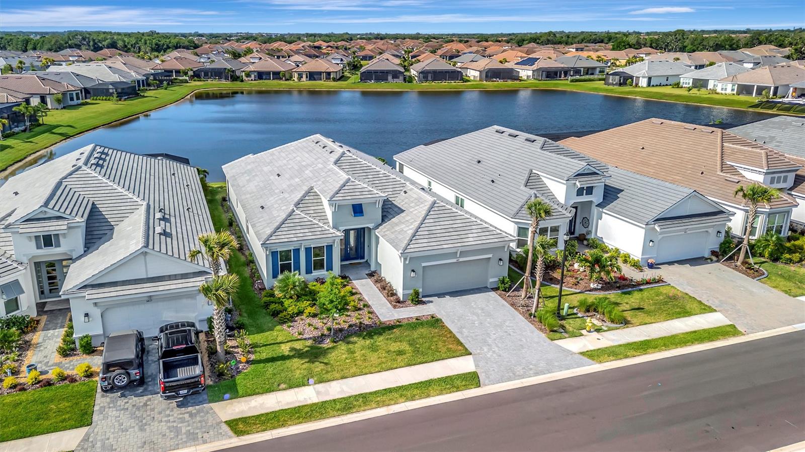 Esplanade at Artisan Lakes / Esplanade North at Artisan Lakes — nearly new Palazzio model with tranquil water views, luxury upgrades, and resort-style living in one of Palmetto’s most desirable gated communities.  This beautifully designed 2025 home offers 3 bedrooms, 3 full baths, 3,089 sq ft, and an open, light-filled floor plan created for comfortable everyday living and effortless entertaining. Buyers searching Esplanade at Artisan Lakes will want to see this one.  From the moment you enter, the home feels elegant, spacious, and move-in ready. The main living areas feature beautiful finishes, abundant natural light, and a seamless flow from the kitchen, dining, and gathering spaces to the extended screened lanai overlooking the water.  The designer kitchen is a true centerpiece with quartz countertops, GE Café appliances, gas cooking, wine refrigerator, reverse osmosis water filtration, generous cabinetry, and a large island ideal for entertaining. The open great room and dining area create the perfect setting for hosting family and friends or simply relaxing at home.  The extended screened lanai is one of the home’s standout features, offering peaceful pond views, covered outdoor living space, and a gas fireplace for year-round enjoyment. Whether you are enjoying morning coffee, evening sunsets, or outdoor entertaining, this space captures the Florida lifestyle beautifully.  The private owner’s suite offers a relaxing retreat with water views, generous closet space, and a spacious bath. Two additional bedrooms and two full guest baths provide comfort and flexibility for family, guests, or a home office.  Additional features include impact windows and doors, a spacious tandem garage with room for golf cart storage, exercise equipment, hobby space, or additional storage, and a non-flood zone location for added peace of mind.  Located in Esplanade North at Artisan Lakes, part of the highly desirable Esplanade at Artisan Lakes lifestyle community, residents enjoy resort-style amenities including clubhouse, fitness center, resort pool, spa, pickleball, tennis, walking trails, dog park, social activities, and golf-cart-friendly streets. Conveniently located near I-75, this home offers easy access to St. Petersburg, Tampa, Sarasota, Bradenton, Lakewood Ranch, Gulf beaches, shopping, dining, and area airports.