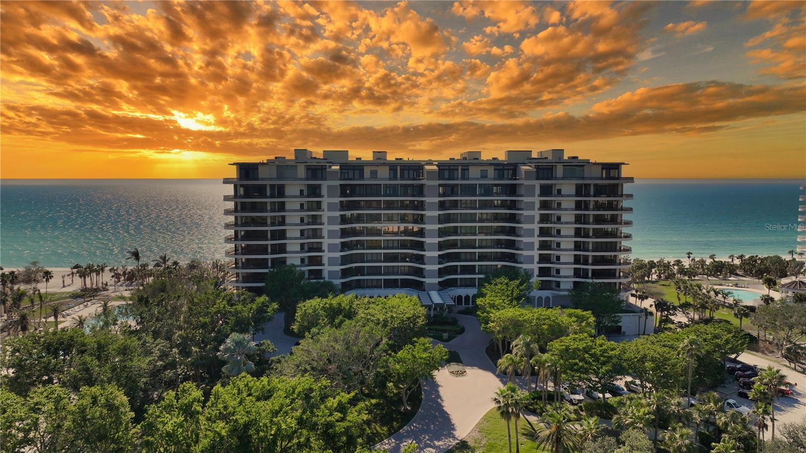 Sunrise to Sunset Views - Your Coastal Paradise awaits you at L'Ambiance!**  2 bedrooms with an open den --step into a world of instant enjoyment. Nestled along the stunning Gulf of Mexico, L'Ambiance offers you a front-row seat to Sarasota's dramatic sunrises and captivating sunsets. This exceptional corner residence is a rare gem, designed to help you create a lifetime of cherished memories. As you glide off your private elevator into the foyer, prepare to be mesmerized by panoramic views that seamlessly blend the indoors with the stunning outdoors. Meticulously crafted by a professional decorator, this residence is a masterpiece of elegant living, featuring expansive glass walls that invite the beach's natural beauty into your home. Enjoy the custom kitchen and luxurious bathrooms, all adorned with travertine flooring in the main living areas and plush carpeting in the bedrooms. Imagine sipping your morning coffee on the east terrace, soaking in the breathtaking sunrise, or toasting to the magical afterglow of sunset with a glass of champagne on the southwest terrace. This spacious 2-bedroom (plus den or 3-bedroom) and 3.5-bathroom residence exemplifies the pinnacle of beachside luxury. Your maintenance fee ensures a stress-free lifestyle, covering everything from the building's exterior and cable service to flood insurance and on-site management so that you can immerse yourself fully in the extraordinary island living experience. With concierge services, a resort-style pool and spa, guest suites for visitors, and a state-of-the-art fitness center, L'Ambiance offers amenities that elevate your everyday life. Sarasota's pristine white, sugar-sand beaches are just the beginning! Dive into a vibrant cultural scene to enjoy the Sarasota Opera, the Sarasota Ballet, and the West Coast Symphony. Explore the renowned Ringling Museum of Art, wander through charming art galleries and antique shops, or indulge in exquisite dining at world-class restaurants. Whether you crave the excitement of marinas and golf courses or the casual charm of local cafes, Sarasota truly has it all. Make this luxurious beachfront residence your new home and embrace the unparalleled lifestyle that awaits you at L'Ambiance. Your dream of extraordinary living is just a step away!