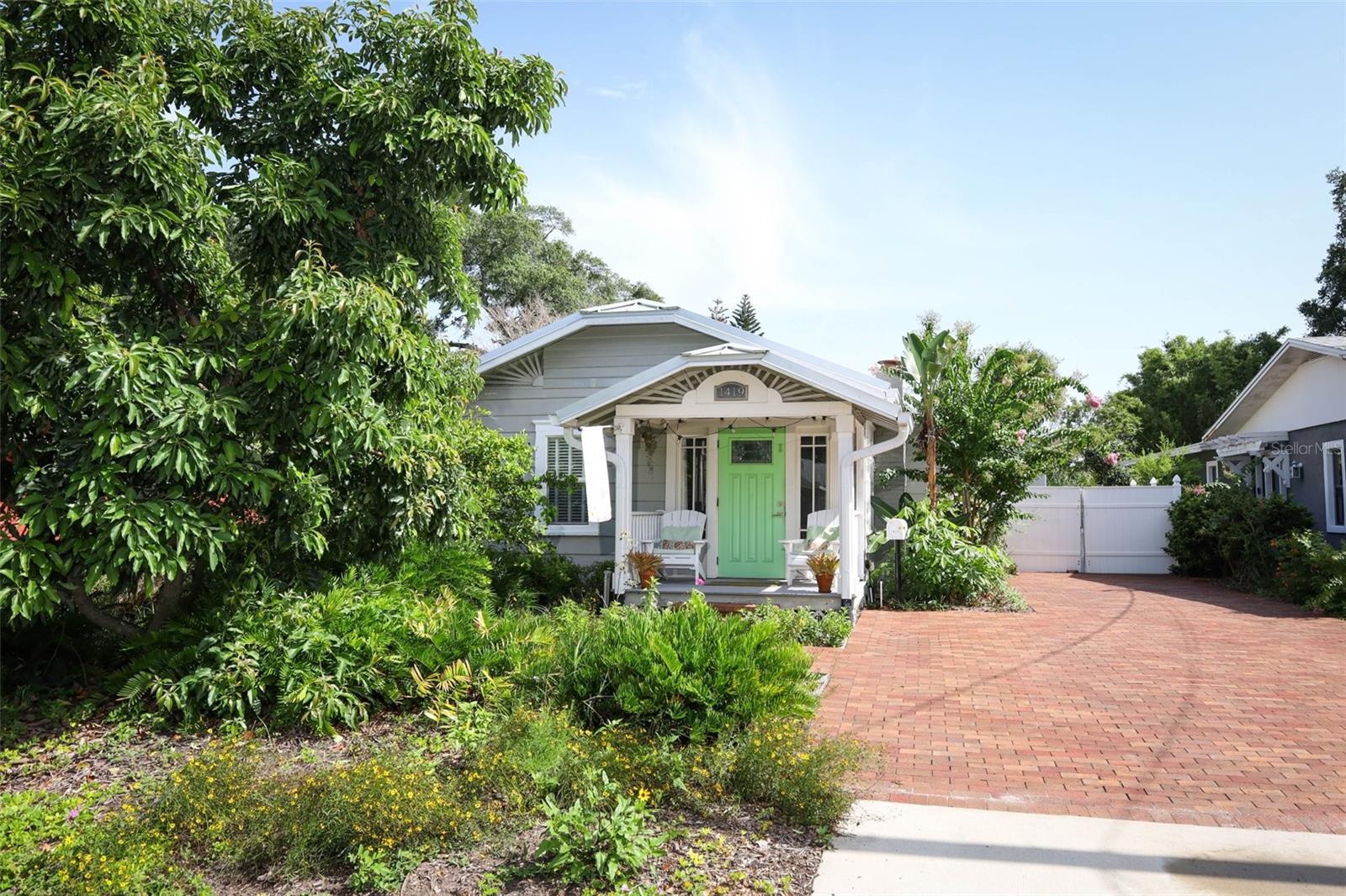 Charming bungalow in the heart of Colonialtown north/mills 50. Move in ready, Fully updated with high end finishes. Metal roof installed in 2020. Florida sunroom added in 2022 giving the home an additional 270 square feet of living space. Detached garage adds another 400 square feet which could be converted to an additional dwelling unit. Custom clay brick driveway and patio. Emergency power connection capable of powering entire home in case of outages. Power lines to the home are underground, further protecting from power loss. The landscaping is truly Florida friendly with  native and pollinator plants and a variety  can relax in the fantastic jetted hot tub. This home is a slice of paradise in one of Orlando’s most desirable neighborhoods