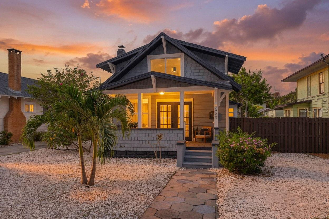 Some homes are renovated. Others are completely reimagined. Welcome to 629 6th Avenue North—an extraordinary Craftsman residence where timeless historic character meets uncompromising modern luxury on one of Historic Uptown's exceptionally rare oversized parcels. Meticulously transformed from the ground up with virtually every major system replaced or upgraded, this is a residence designed for the buyer who refuses to compromise. Beyond the iconic front porch, soaring ceilings, rich hardwood flooring, original crystal door hardware, elegant stained glass, crown molding, designer wall sconces, and smooth drywall finishes create an atmosphere of refined sophistication while preserving the home's architectural soul. The chef's kitchen is a true showpiece, anchored by an exceptional Samsung Café appliance suite featuring a six-burner natural gas range, custom soft-close shaker cabinetry, striking quartz countertops, designer tile backsplash, and thoughtfully curated finishes throughout. The true ground-floor owner's retreat offers the comfort and privacy discerning buyers expect, complete with a spa-inspired bath featuring a soaking tub, oversized walk-in shower, dual vanity, and the convenience of an adjacent laundry room. Upstairs, two guest bedrooms showcase vaulted ceilings, individual Gree mini-split systems, and a beautifully appointed full bath with a skylight, creating an ideal separation of space for family and guests alike. Equally impressive is the outdoor living experience. Professionally designed with lush landscaping, premium turf, extensive hardscaping, an expansive entertaining deck, Rain Bird irrigation system, natural gas service, and a pre-plumbed gas connection for a future outdoor kitchen, the backyard has been curated as a private extension of the home's luxury lifestyle. The detached garage, coupled with zoning that permits a future accessory dwelling unit (ADU), offers exceptional flexibility for a guest house, executive office, fitness studio, or future income-producing opportunity. Behind the scenes, virtually every major improvement has already been completed, including a new 2025 roof, impact-rated windows, new plumbing, Goodman HVAC with Honeywell smart thermostat, Rinnai tankless gas water heater, whole-home water softener, recessed LED lighting, and countless additional upgrades that deliver true peace of mind. Perfectly positioned just moments from vibrant downtown St. Petersburg, waterfront parks, award-winning dining, museums, and boutique shopping, 629 6th Avenue North represents a rare opportunity to own a fully restored Historic Uptown masterpiece where enduring craftsmanship, modern luxury, and exceptional outdoor living come together in one unforgettable residence.