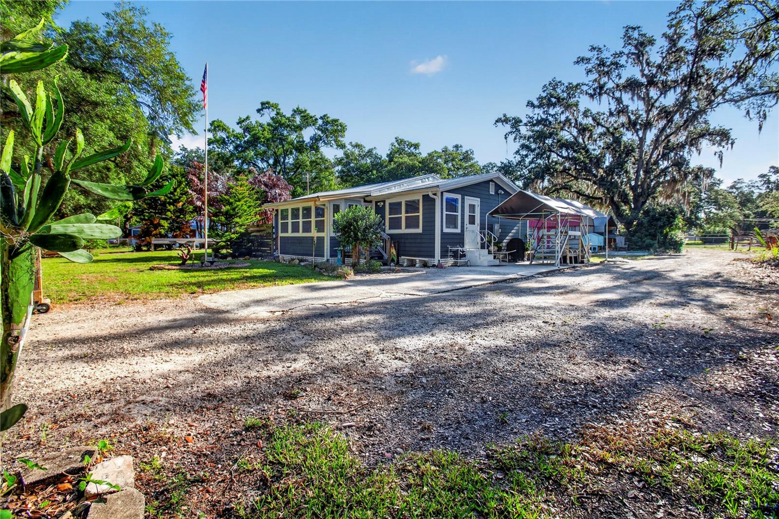 Can easily be converted back into a 2 bedroom home. Seller credit of $5,000 toward converting back to a 2-bedroom with acceptable offer. Roof: 2017 HVAC: 2017 Water Heater: 2016 Escape the noise and step into a lifestyle defined by space, privacy, and fresh country air—while still enjoying easy access to everything you need. Nestled on nearly 3 acres, this unique property offers the perfect blend of peaceful rural living and everyday convenience, just a short drive from Tampa, major highways, shopping, dining, and top employers .
Surrounded by mature trees, open skies, and natural beauty, the setting invites you to slow down and enjoy life outdoors—whether it’s morning coffee under the shade, evenings by the gazebo, or simply taking in the quiet. The expansive, fenced land features multiple pastures and a picturesque creek, creating a serene environment with room to grow, garden, or explore new hobbies .
The home itself is thoughtfully updated and designed for comfortable, easy living, with an open layout, a bright sunroom, and a spacious primary suite. The kitchen stands out with quality finishes and generous workspace, ideal for gathering and everyday living .
Additional structures - including workshop space, storage buildings, and covered parking—offer flexibility for projects, equipment, or creative pursuits. Whether you’re seeking a quiet retreat, space to spread out, or a property with room to adapt to your lifestyle, this one delivers.
Experience the calm of country living where you can unwind, breathe deeper, and still be just minutes from the conveniences that matter.