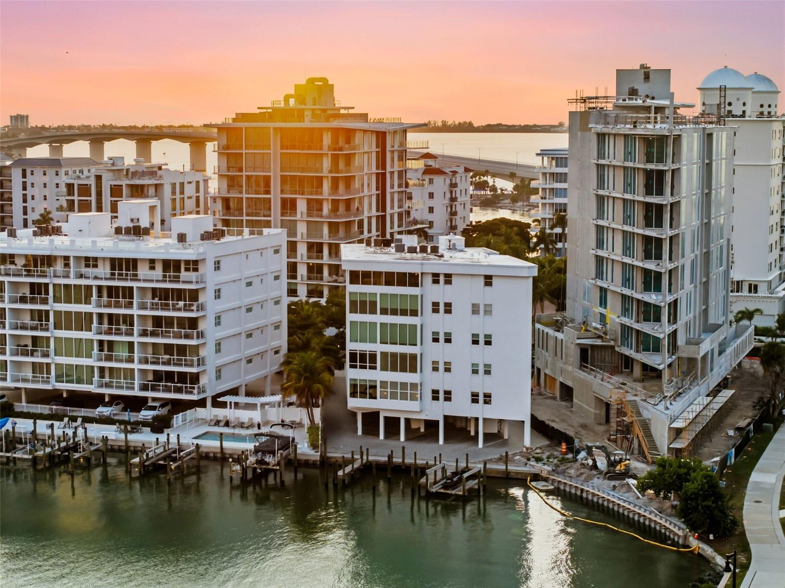 Set within a boutique waterfront building in Downtown Sarasota’s coveted Golden Gate Point, this exceptional penthouse offers a rare combination of privacy, sophistication, and true coastal living. Encompassing approximately 3,400 square feet, the residence includes two reserved parking spaces and a deeded boat slip accommodating a 30-foot vessel, delivering an unmatched opportunity for immediate access to Sarasota Bay boating. A private elevator opens directly into the residence, revealing an expansive open-concept layout designed for both everyday comfort and effortless entertaining. The kitchen, living, and dining areas flow seamlessly together, all framed by sweeping 180-degree unobstructed water and skyline views spanning Marina Jack, Sarasota Bay, and the sparkling Downtown Sarasota skyline. Sunsets and city lights become part of the daily experience, creating a backdrop that is both serene and visually striking. The primary suite is thoughtfully positioned apart from the guest wing, offering a private retreat with peaceful separation. Guests enjoy a well-appointed en-suite bedroom, while a flexible den provides the option for a third bedroom or dedicated office. An in-unit laundry room and abundant storage throughout enhance the functionality of this full-time residence. The building itself has recently undergone key improvements, including a new roof and refreshed second-floor common area with updated glass enclosures, adding to its long-term value and appeal. Perfectly located just moments from the John Ringling Bridge, Marina Jack, the Downtown Sarasota Farmers Market, world-class dining, and the Sarasota Yacht Club, this penthouse delivers the ultimate blend of walkable downtown convenience and premier waterfront boating access. A rare opportunity to own a true Sarasota Bay penthouse lifestyle — where luxury living meets direct boating access from your private slip.