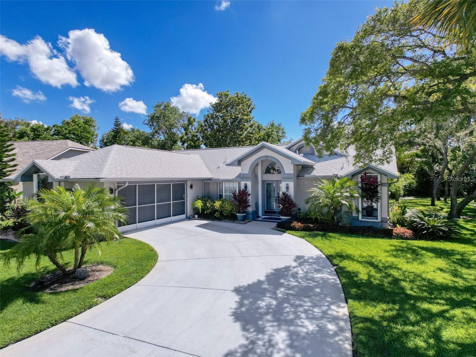 Pull into your sweeping driveway to see your home with a freshly painted exterior. Loaded with upgrades from top to bottom, HVAC and water softener 2019, roof and gutters 2021. Open floor plan with a breakfast bar, eat-in kitchen with light designer shaker cabinets, soft close drawers and doors. Let's not forget the refrigerated wine cooler and separate wine rack. Granite countertops throughout the kitchen. Great Room has built in shelves designed for your TV and flat glass electric fireplace. Both baths have granite or designer tile countertops and jetted tub with tiled shower in the primary ensuite. Engineered hardwood floors in main living areas and lighter porcelain tiled floors in kitchen and baths. All the rear rooms view the screened lanai, 2 side  patios and the oversized peaceful, private fenced backyard. All doors and most windows have hurricane shutters. Low HOA dues provide a beautiful clubhouse, fitness center with newer machines, pool, pickleball, basketball, Tennis courts, bocci and shuffleboard. Bring your fishing gear and kayak as  you are a few miles off the Gulf of America. Don't forget to pack your golf clubs to play the many public courses nearby.