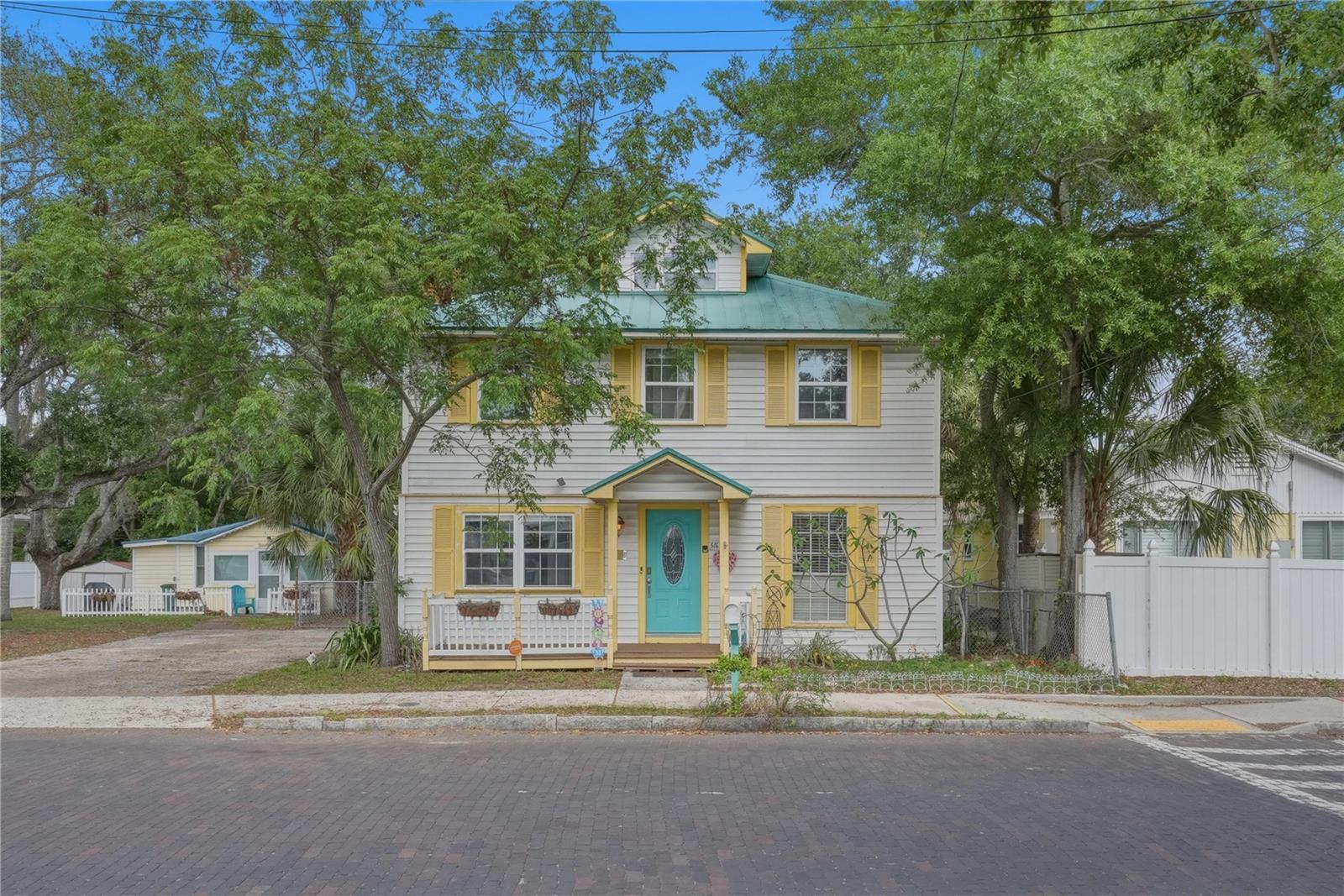 NO FLOOD ZONE. Rare opportunity just steps from downtown Safety Harbor on the coveted cobblestone stretch of 5th Avenue.

Originally built in 1925 during the height of the Sears & Roebuck catalog home era, this classic American Foursquare features the enduring craftsmanship of early 20th-century construction, including dense old-growth lumber known for its exceptional strength and longevity. While thousands of these homes were built nationwide, only a limited number of comparable early 20th-century homes remain in Florida today.

Featuring tall ceilings uncommon for homes of this era, the property offers a unique sense of openness and character throughout. Spanning over 2,700 square feet across three levels, the home offers 4 bedrooms, 3 bathrooms, bonus/flex spaces, a loft, and a layout ideal for buyers seeking something distinctive and full of personality. The primary suite features a private balcony, dual walk in cloests and a remodeled bathroom retreat.

Inside, you’ll find an open kitchen with an island, dedicated laundry room, elegant laminate flooring, and a wood-burning fireplace with a chimney that adds warmth and historic charm to the living space. Flexible living areas throughout the home provide endless possibilities for guest space, offices, creative studios, or additional entertaining areas.

Outside, a welcoming back patio overlooks the spacious backyard, offering endless potential to create your own outdoor retreat, whether it’s a garden, entertaining space, or future vision. A long-lasting metal roof adds additional value and peace of mind, while the cobblestone street setting enhances the home’s undeniable charm and sense of arrival.

Walkable homes this close to downtown Safety Harbor are exceptionally rare. Just four blocks from restaurants, coffee shops, the pier, live music, art festivals, boutiques, Third Friday celebrations, and the world-famous Safety Harbor Spa.

Whether you’re looking to restore, personalize, invest, or simply own a truly distinctive property in one of Tampa Bay’s most beloved waterfront towns, opportunities like this rarely come available.