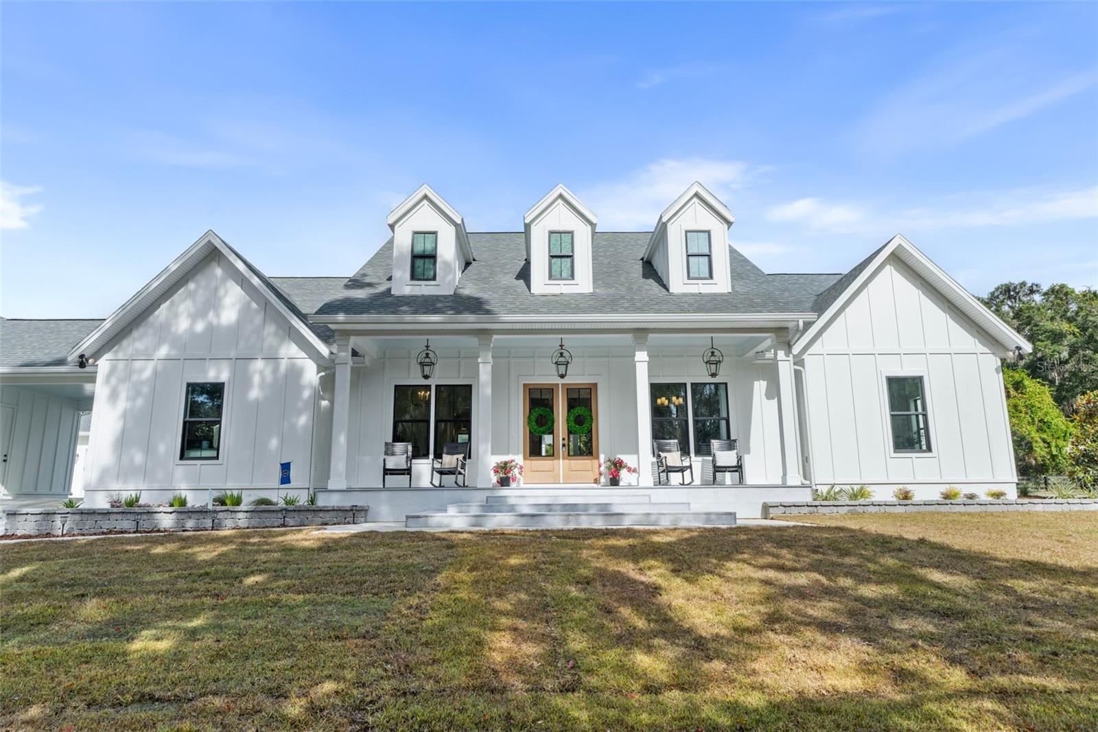 Experience refined estate living in this custom-built residence within Barrington, Gainesville’s premier gated community. Set on two private acres surrounded by majestic oaks, this home blends timeless architecture with modern comfort and meticulous craftsmanship. Spanning  nearly 4,000 square feet, it offers four bedrooms, four and a half baths, a dedicated office, and a spacious game/media room that opens to a veranda and resort-style pool—ideal for both everyday living and effortless entertaining. The open-concept great room centers around a striking fireplace and flows seamlessly to the outdoor living area, complete with a second fireplace and expansive covered lanai.

The gourmet kitchen showcases GE Monogram appliances, Cambria quartz countertops, and custom cabinetry, while COREtec Pro Enhanced Cairo Oak flooring provides the beauty of hardwood with waterproof durability. Designer Visual Comfort lighting and elegant finishes elevate every space. The primary suite serves as a private retreat, featuring a spa-style bath with a soaking tub, walk-in shower, and dual vanities. Additional highlights include a porte-cochère, four car garage, and well-planned storage and laundry areas that combine luxury with functionality.

Homeowners enjoy peace of mind with a Maverick Structural & Home Warranty, including one-year workmanship coverage, two-year systems protection, and ten-year structural coverage, plus the HomeCare Program’s dedicated support and 11-month review process. Ideally located just minutes from Tioga Town Center, Publix, UF, and I-75, Barrington offers tranquility, convenience, and exclusivity—defining luxury estate living in North Florida.