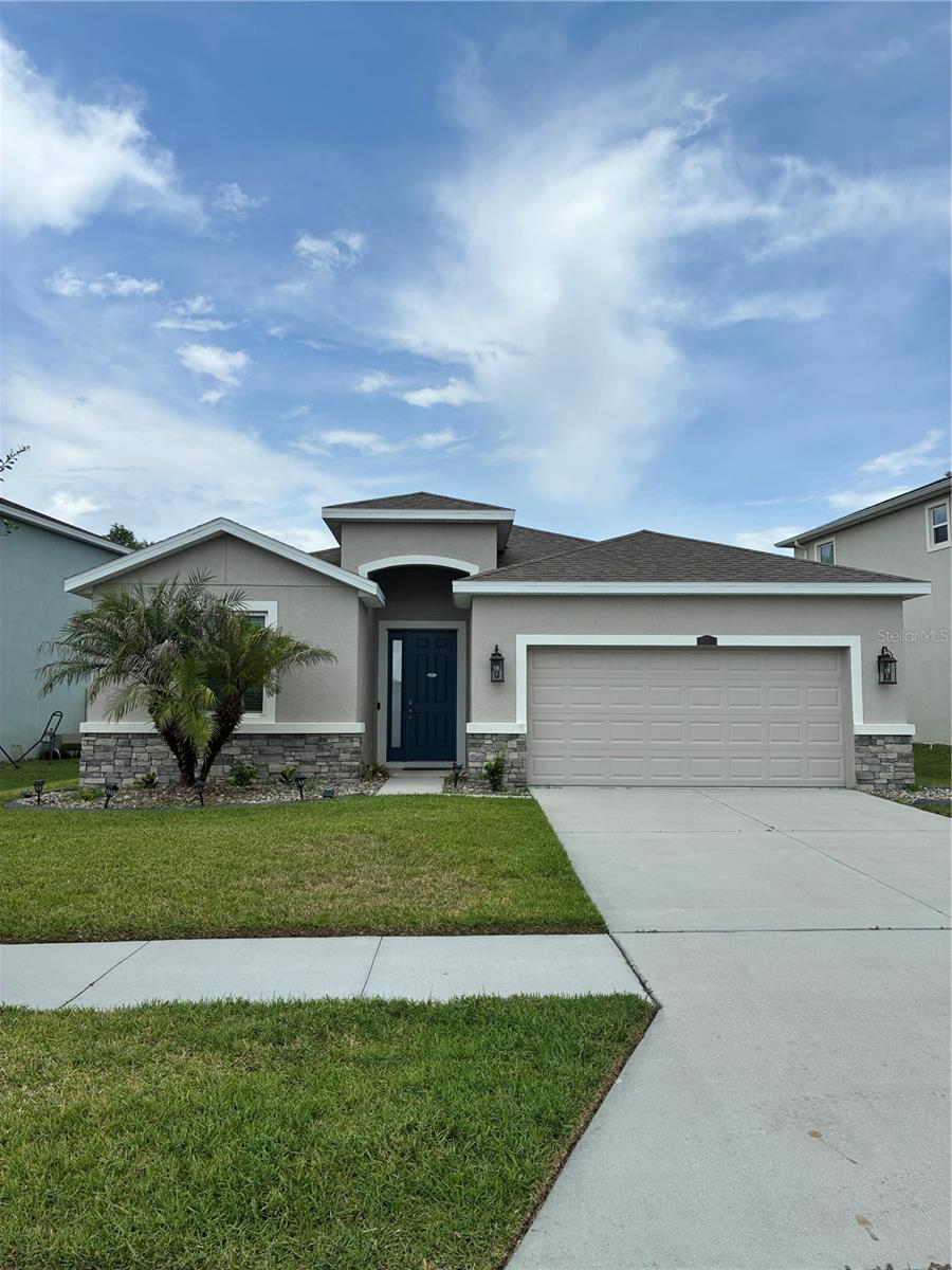 INTERNET, CABLE & LAWN CARE INCLUDED • FENCED BACKYARD • SCREENED LANAI • CONSERVATION VIEWS • NO CARPET • SMART HOME • ACCESS TO THE CRYSTAL LAGOON • EPPERSON RANCH 4 BEDROOM, 2.5 BATHROOM, 2 CAR GARAGE SMART HOME WAITING FOR YOU! Located very close of the renowned Crystal Lagoon and community recreation area, this beautifully maintained home offers the perfect combination of comfort, convenience, and Florida living. Inside, you'll find luxury vinyl plank flooring throughout, neutral colors, and an open-concept layout designed for both everyday living and entertaining. The spacious family room flows seamlessly into the kitchen and dining area, creating a bright and inviting gathering space. The kitchen features stainless steel appliances, stylish gray cabinetry, ample storage, a generous pantry area, and a large center island perfect for seating, meal prep, and entertaining. The thoughtfully designed floor plan offers three secondary bedrooms and a full bathroom toward the front of the home, along with a convenient laundry room. Privately situated at the rear of the home, the primary suite enjoys peaceful conservation views, dual walk-in closets, and a well-appointed en-suite bathroom featuring dual vanities, a large soaking tub, separate shower, and private water closet. Step outside to the oversized screened lanai overlooking the conservation area and enjoy the privacy of your fully fenced backyard with no rear neighbors. This move-in ready home is located in one of Wesley Chapel's most sought-after communities with easy access to shopping, dining, schools, major roadways, and all the amenities Epperson Ranch has to offer. Don't miss this opportunity to live in one of the area's most popular communities!