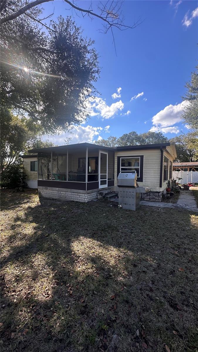 Short Sale. Manufactured home located in a well established subdivision with convenient access to I-4, Disney, shopping, and everyday amenities. The home is not in show condition and will require some TLC, making it a great opportunity for buyers looking to add value. The 1,057 square foot layout offers two bedrooms and one full bathroom, plus a large bonus room off the living area that could be converted into a third bedroom, office, or flex space. The property features a screened front room, concrete driveway, metal roof, and lap siding. A large detached shed will stay with the property providing excellent storage or workshop potential. Priced to reflect condition and offering strong upside in a desirable location. Schedule your showing today.