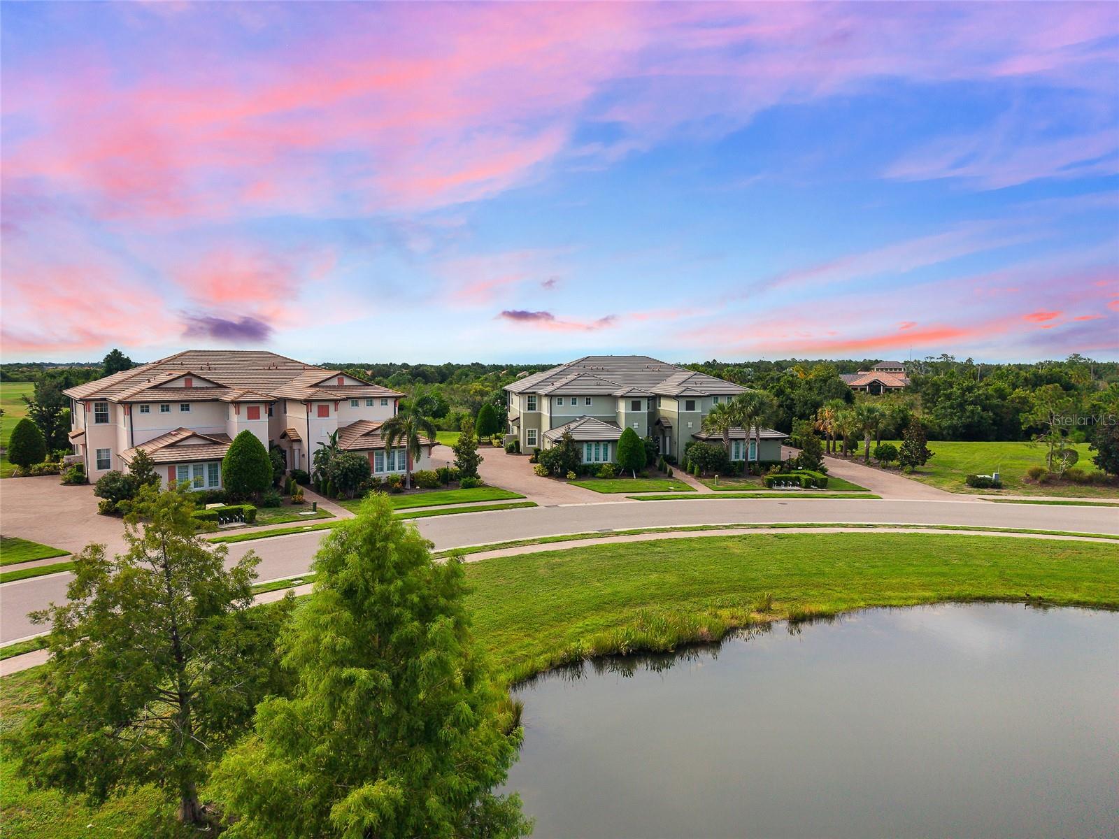 Virtually Staged. Welcome to the only first floor condo available in Lakewood Ranch’s distinctive Country Club East. This Clubside offering provides everything you could want in your next home; an exclusive address, sunset golf course views, end unit privacy, resort style pools, fitness centers, clubhouse and the convenience of being able to walk out and enjoy the greenspace around the home. The location cannot be beat. While maintaining fantastic views, one can enjoy the privacy of being well away from the activities at the nearby community center. Entering the home, guests are greeted with the view of the golf course and preserve from everywhere in the main living area. The open floor plan allows the easy flow from the kitchen to the living/dining area to the screened large screened-in lanai. The kitchen will motivate your inner Julia Child with its stainless steel appliances and beautiful quartz counters and island allowing all the prep space for the next party or family gathering. There is loads of storage in the kitchen including a walk-in pantry.  The primary suite has direct access to the lanai where you can slip away for your morning coffee and commune with nature. The primary bath features a curbless shower and dual vanities. The laundry area features built-in cabinetry, a designer wash sink and includes washer & dryer. The home comes complete with design and convenience elements like trayed ceilings, crown molding, on-demand hot water, and IMPACT DOORS & WINDOWS. An attached two-car garage also includes overhead storage. A Lakewood Ranch address gives you a home in the number one multi-generational community in the country featuring A-Rated schools, easy access to great health care, transportation to 3 convenient airports, two award winning downtown areas in LWR Main Street and the new Waterside featuring exclusive shops and restaurants.