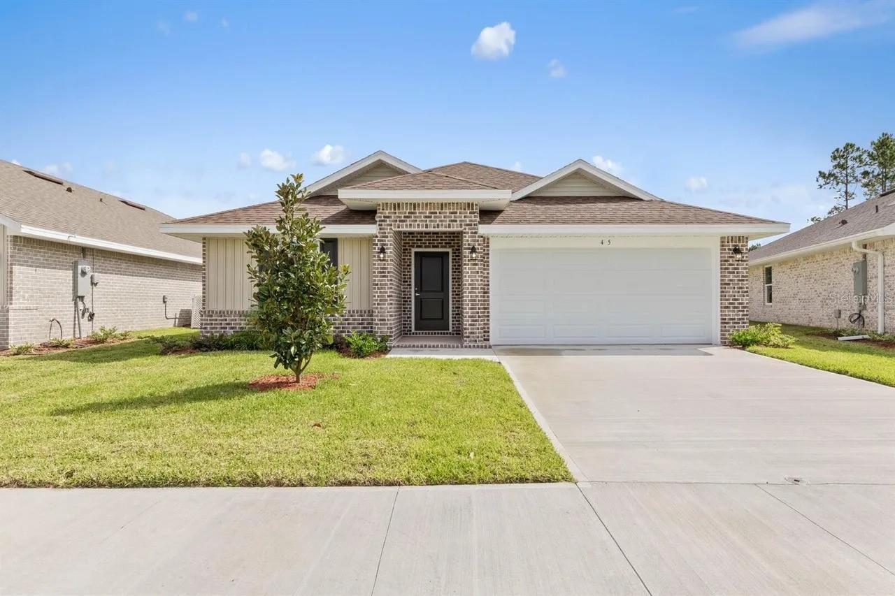 Under Construction. Welcome to your brand new dream home in beautiful Palm Coast. With NO HOA or CDD, this thoughtfully designed REAL BRICK 1512 floor plan offers the perfect blend of comfort, functionality, and modern style. With 3 bedrooms, 2 full bathrooms, and 1,523 square feet of living space this home is ideal for anyone looking to enjoy Florida living at its finest. Picture a home that matches where you’re headed — security, comfort, and the ability to live the life you’ve been planning. Step inside to discover an inviting layout with a seamless flow between the living, dining, and kitchen areas—perfect for entertaining or everyday living. Imagine having a kitchen built for real cooking and real gatherings… a backyard ready for weekend relaxation… or a dedicated room that finally gives your work-from-home setup the space it deserves. The modern kitchen features sleek granite countertops and plenty of cabinet space, opening to a large family room that leads out to the backyard and a 16x7 covered rear patio. The private owner’s suite offers a peaceful retreat with an en-suite bath featuring dual vanities and a five foot shower stall with glass door. Two additional bedrooms provide ample space for guests, a home office, or hobbies. Situated in the Indian Trails “B” Section in Palm Coast, you’ll enjoy close proximity to local parks, beaches, shopping, dining, and schools. With quality construction and builder’s warranty, you can buy with confidence.  When you choose the right home at the right time, you gain more than square footage — you build equity, stability, and the freedom to enjoy each day more fully. Whether you’re looking for your first home, a forever home, or a vacation escape, the 1512 plan is a must-see!  Step into a smarter investment and a home that feels like an upgrade to every aspect of your life. Take ownership of your future — and start loving where you live the moment you walk through the door. Schedule your showing today and experience Florida living your way! Only $1,000 deposit required & MOST CLOSING COSTS PAID WHEN USING AN APPROVED LENDER, SAVING BUYERS THOUSANDS OF DOLLARS!!  **Photos are not of actual home and are for illustration purposes only. Finishes/colors may vary from photos**