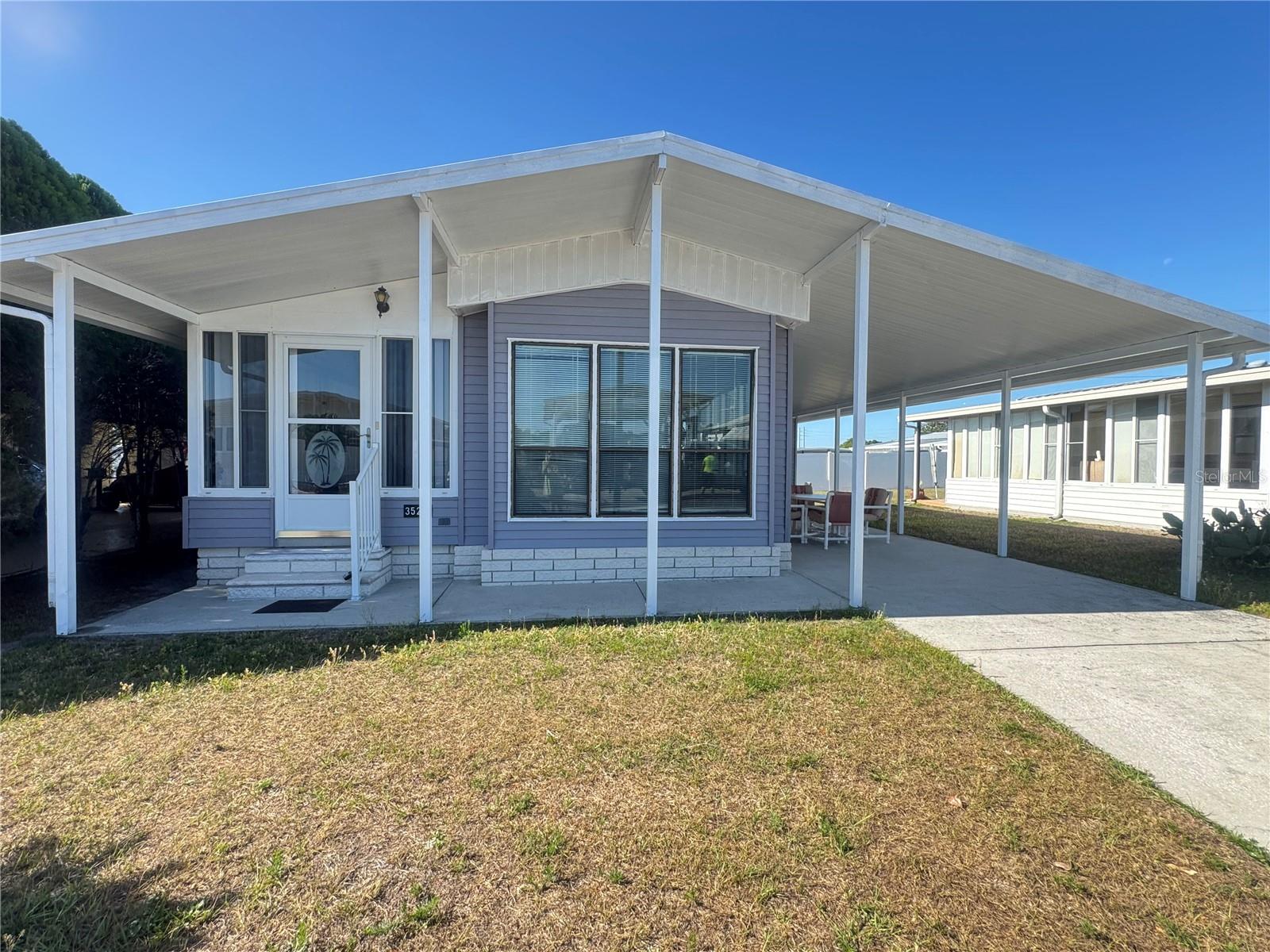 Located in a desirable 55+ Community in Zephyrhills, this charming 1-bedroom, 1-bath home offers comfortable living with the added benefit of you own the land - no lot rent.  The spacious Florida room provides additional living space& entertaining space, while the bonus room offers flexibility as a home office, hobby room or guest bedroom.  The Master bedroom has built-in drawers and closets to store your clothes. The kitchen features a glass-top electric range and microwave with a hood for everyday convenience.  Outside, the l0'x 26' carport provides ample covered parking and space for outdoor entertaining and the 11'x 8' shed includes a washer and dryer plus extra storage/workshop space.  Situated in a quiet neighborhood with all the appeal of active adult living, this property is ideal as a seasonal retreat or full-time residence.American Condominium Park is a 55+ gated community with heated pool, clubhouse, exercise room, sauna, hot tub, tennis/pickleball courts, horse shoe pits, shuffleboard, and many more amenities.  A friendly, active community with dances, dinners, and entertainment.  Perfect for full time affordable living and cost effective for snow birds.  No rent as you own the land.  Reasonable monthly fee that maintains the common elements and amenities for your use.  Call today for a viewing.