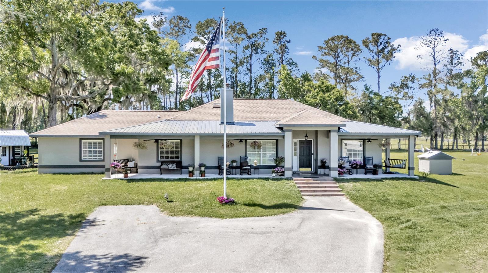 Welcome to the epitome of equestrian living at the doorstep of the World Equestrian Center!  Nestled across the street from this prestigious venue, this enchanting horse farm offers a rare opportunity to immerse yourself in the heart of the equestrian world.  Spanning nearly ten acres of lush Florida pastures with gorgeous granddaddy oaks, this meticulously maintained property showcases a charming residence and an array of amenities tailored to the equestrian lifestyle.  Boasting 2,106 square feet of living space, the home welcomes you with inviting ambiance and tasteful finishes. Featuring three bedrooms and two baths, extra large flex room, open floor plan, granite counters and stainless appliances.  Ceramic tile runs through most of the home and travertine tile in the bathrooms.  Cozy up by the fireplace in the spacious living area, creating a warm and inviting atmosphere for relaxing evenings.  Step outside and you'll discover a fully functional equestrian facility designed to meet the needs of both horse and rider. There’s a ten-stall barn with two rooms under AC for tack, two wash racks, ten large turnout paddocks, and a jump field.  The shop built in 2020 is 3600 square feet and mostly under air with additional lean-to space for storage on the back of the building.  And chill out in “Andy’s Bar” after work in a spacious man cave inside the shop.  Additionally, two "tiny houses" provide cozy accommodations for barn staff or guests, and two RV hookups as well.  Roof and HVAC replaced in 2017.