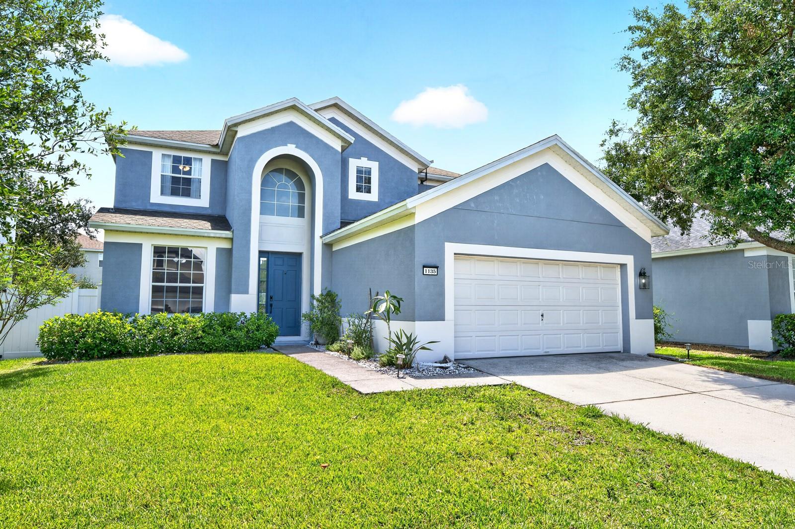 Room to grow, thoughtful UPDATES, and an incredible BACKYARD RETREAT make this spacious two-story home in the sought-after GUARD GATED COMMUNITY of Spring Isle one you won't want to miss! Ask us about the BRAND-NEW ROOF to be installed prior to closing – additional improvements include FINISHED CONCRETE FLOORS (2023), a PRIVACY FENCE (2020), a beautifully REMODELED PRIMARY BATHROOM (2020), attic flooring with pull-down ladder for additional storage (2020), and updated interior finishes and newer appliances throughout. Designed with flexibility in mind, this 5-bedroom, 3.5-bath SPLIT BEDROOM FLOOR PLAN also includes an enclosed second floor BONUS ROOM and a versatile FLEX SPACE at the front of the home that's perfect as a home office, formal dining room, library, or playroom. A dramatic TWO STORY FOYER greets you as you step through the front door, where abundant natural light and open living spaces create an inviting atmosphere. The current owners especially love the functional layout, spacious MAIN FLOOR PRIMARY SUITE, large open kitchen, bonus room, and the backyard oasis that makes everyday living feel like a getaway. The open-concept kitchen is a dream for the home chef, featuring granite countertops, NEWER STAINLESS STEEL APPLIANCES, abundant cabinet and prep space, an oversized ISLAND with bar seating, pantry storage, and seamless flow into the living and dining areas for easy entertaining. Tucked away on the first floor, your primary suite offers a peaceful retreat with its beautifully remodeled en-suite bath and WALK-IN CLOSET, while upstairs you will find four additional bedrooms and the enclosed bonus room, giving everyone space to spread out. Step outside and embrace the Florida lifestyle you have been dreaming of. The fully fenced backyard is designed for relaxing and entertaining with a generous COVERED LANAI, paver patio, CUSTOM BUILT-IN PERGOLA & SPA, and mature trees that create a private outdoor escape. Spring Isle is one of East Orlando's most desirable guard-gated communities, offering RESORT STYLE AMENITIES including a community pool, clubhouse, playground, and dog park, and the HOA conveniently INCLUDES LAWN CARE for low-maintenance living. Ideally located near Avalon Park, you will enjoy easy access to local dining, boutique shopping, community events, SR-408, SR-417, Alafaya Trail, UCF, Downtown Orlando, Orlando International Airport, and Florida's beautiful beaches. Spacious, beautifully updated, and packed with features inside and out, this is the lifestyle you have been waiting for. Call today to schedule a tour and fall in love with your new HOME SWEET HOME!