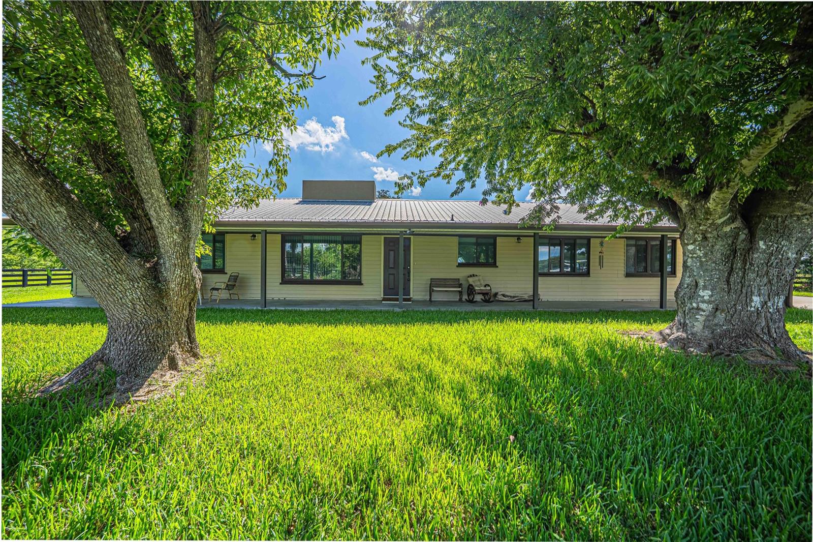 Welcome to your own slice of Old Florida! Situated on approximately 13 beautiful acres in Okeechobee, this well-maintained ranch-style home offers the perfect combination of privacy, functionality, and country living. Inside, you'll find over 2,000 square feet of living space featuring 3 bedrooms, 3 bathrooms, multiple living areas, a spacious family room with a stunning brick fireplace, and an updated kitchen with abundant cabinet and counter space that's perfect for everyday living or entertaining. The home's thoughtful layout provides plenty of room for family gatherings while still offering comfortable private spaces. Step outside and enjoy everything this property has to offer. Relax on the expansive screened porch overlooking the peaceful acreage, or take advantage of the impressive 4-stall open pole barn, ideal for equipment, RVs, boats, trailers, livestock, or hobbies. The fenced property offers endless possibilities for horses, cattle, farming, recreation, or simply enjoying wide-open space and breathtaking Florida sunsets. Whether you're searching for a full-time residence, weekend retreat, or hobby farm, this property delivers the freedom and flexibility that rural living is all about—all while being just a short drive from town. If you've been dreaming of acreage, privacy, and a move-in-ready home with room to grow, this is an opportunity you won't want to miss.