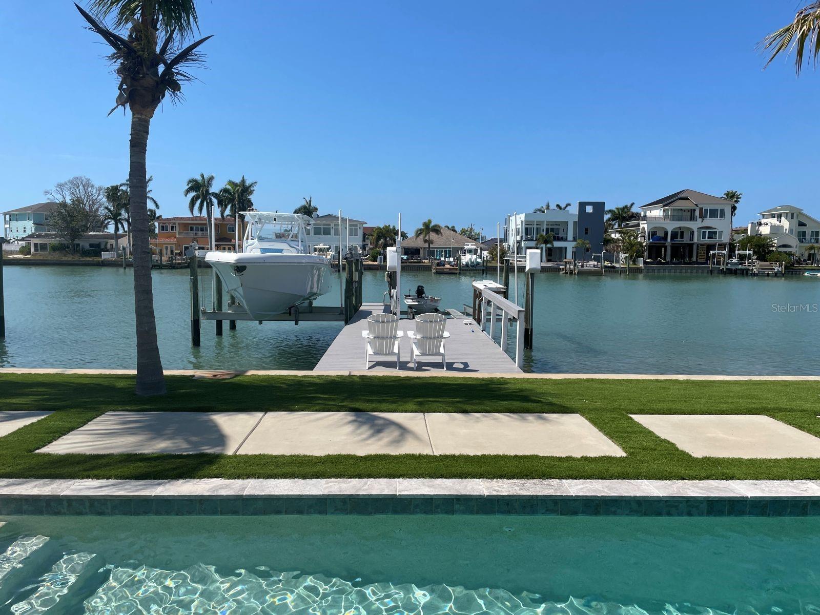 WATERFRONT HOME in Treasure Island! Situated on a Saltwater Canal with DEEP WATER ACCESS to the Gulf. This cute house for boat lovers is a dream come true, offering the perfect blend of comfort and convenience.
The property features a private Dock, a Boat Lift with 24,000 Lbs. capacity and a dual 16,000 lb. Jet Ski Lift on a Composite Dock with water/electricity. Enjoy your fishing days with a Fish Cleaning Station and Outdoor Shower. Stunning outdoor living space featuring a Custom 40-ft Inground HEATED-Lap Saltwater Pool with integrated SPA bordered with Artificial Grass and Coconut Trees, perfect for enjoying the Florida sun and water. Pool equipment is controlled by your phone. Expansive Covered Patio with a Grill area and a Lanai protected by IMPACT-RATED SLIDING DOORS and IMPACT ROLLING SHUTTERS. 
The house features an Open plan, providing a lot of Natural Light. IMPACT-RATED WINDOWS and DOORS. Porcelain Tiles All Around. Brand-New Gourmet Kitchen with Quartz Countertops and Backsplash, Stainless Steel appliances, Induction Cooktop, 4-Doors Refrigerator, Microwave-Oven Combo, Dishwasher, Food Disposal and Dishwasher. Washer/Dryer combo is in the Utility Room. Contemporary Bathrooms with Cascade and Rain Shower Heads. Walk-in Showers creating a serene and inviting atmosphere. New AC Unit and New Water Heater.
