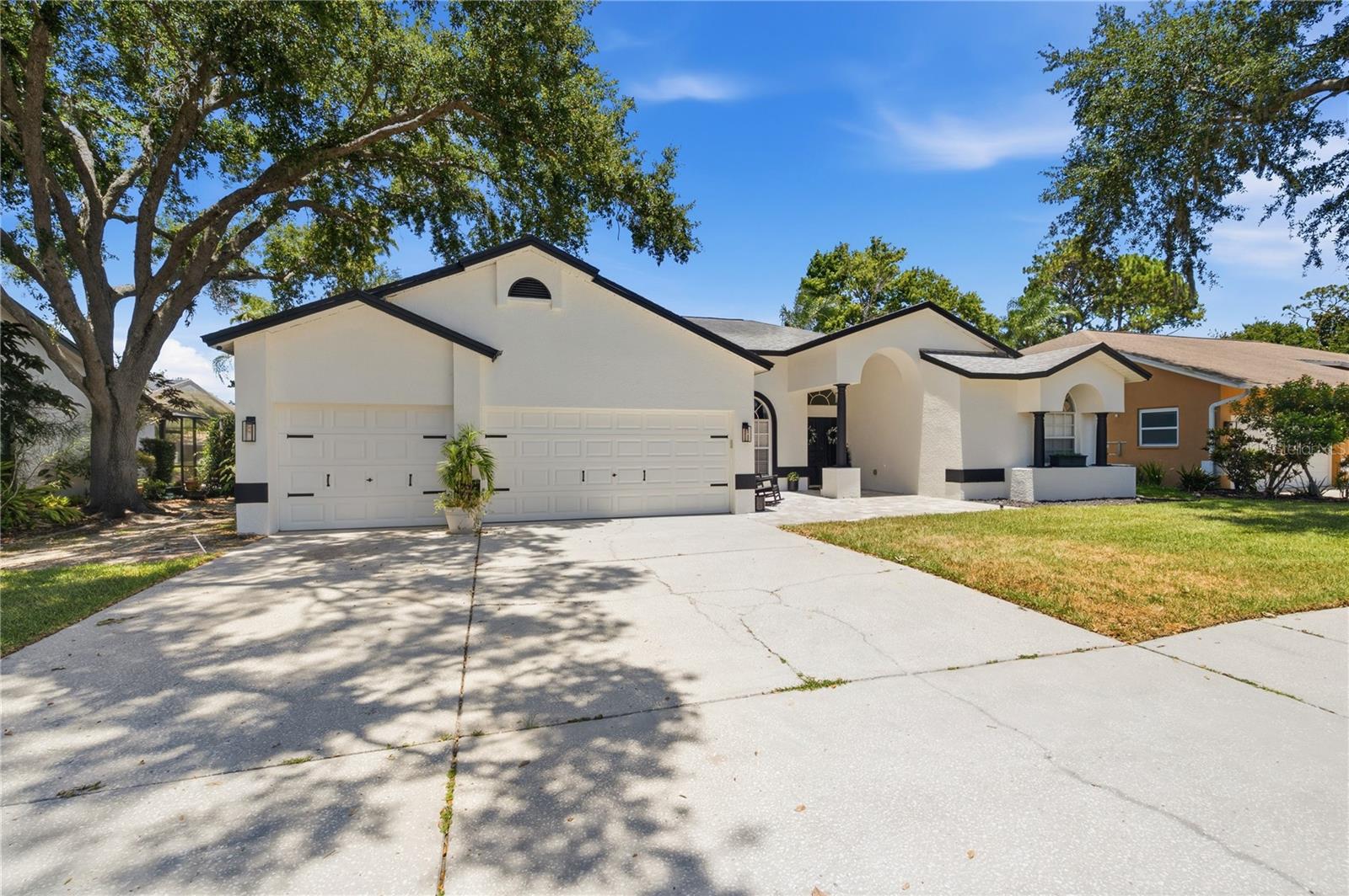 Welcome to this beautifully updated 4-bedroom, 3-bathroom pool home with a 3-car garage, located in the highly desirable gated community of Windemere at Ridgemoor. With an open-concept floor plan and generous living spaces, this home is ideal for both everyday living and entertaining.

Thoughtfully renovated throughout, the home features wood-look tile flooring across most of the living areas, fresh interior and exterior paint, updated lighting fixtures, and beautifully remodeled bathrooms.

The desirable three-way split floor plan offers privacy for everyone. The spacious primary suite overlooks the pool and lake, and features a large walk-in closet, dual vanities, a soaking tub, and a separate walk-in shower. Two additional bedrooms and a full bath are centrally located, while the fourth bedroom is tucked away in its own private wing with an adjacent bathroom that also serves as the pool bath—perfect for guests or a multigenerational living arrangement.

The main living areas open seamlessly to the screened lanai, where you'll enjoy peaceful lake views, a private pool, and attractive paver patios in both the front and back of the home. Every detail has been carefully considered, creating a move-in-ready property with exceptional indoor-outdoor living.

Major system updates include: Roof (2012), HVAC (2024), Water Heater (2019)

Conveniently located near shopping, dining, parks, and everyday amenities just outside the neighborhood, this exceptional home offers the perfect combination of comfort, style, and location. Don't miss your opportunity to own this stunning lakefront home in one of Ridgemoor's most sought-after gated communities.