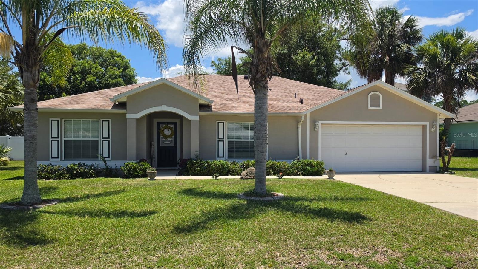 Welcome home to this beautifully maintained 4-bedroom, 2-bath home featuring a desirable split floor plan and open-concept design. Cathedral and tray ceilings create a spacious, airy feel throughout the main living areas, while luxury vinyl flooring adds both style and durability. The oversized eat-in kitchen offers abundant space for gathering and features newer appliances and plenty of room for everyday living and entertaining.

The private primary suite showcases a stunning double tray ceiling, a large walk-in closet, and a relaxing retreat feel. All bedrooms have generously sized closets, with carpeted flooring for added comfort. Additional upgrades include ceiling fans throughout, privacy blinds, 18-inch water-efficient toilets, a security system, Ring doorbell, Blink cameras, and an A/C system enhanced with a Reme Halo in-duct air purifier.

Step outside to enjoy the lanai plus an expansive paver patio overlooking the fully fenced backyard with vinyl privacy fencing and dual gates. Gutters, extra garage storage, two garage door openers, and a garage refrigerator add everyday convenience. With room to add a pool, this backyard offers endless possibilities for outdoor enjoyment!