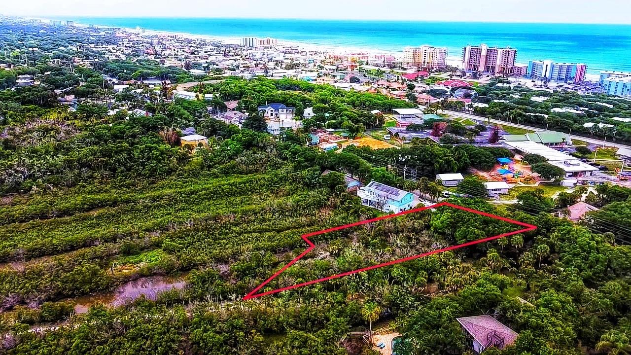 Rare opportunity to own a truly one-of-a-kind beachside parcel in the heart of one of Florida’s most coveted coastal communities. This expansive lot sits just steps from the legendary shores of New Smyrna Beach, offering an unmatched combination of natural beauty, outdoor adventure, and picturesque sunset views.

Nestled along Saxon Drive on the beachside of New Smyrna Beach, this property places you within minutes of the iconic 27th Avenue Beach and Beachfront Park, where world-class surfing and swimming await. The west-facing rear of this lot opens to a breathtaking estuary landscape — a private paradise of waterways, mangrove, and coastal beauty that delivers stunning sunsets and an unmatched connection to nature.

The estuary bordering this property is a living ecosystem teeming with wildlife and world-class fishing. Cast a line, launch a kayak, or paddleboard directly from your backyard with direct access to the tidal creeks, Indian River, and the broader Intracoastal Waterway system. Redfish, snook, and trout fishing are legendary in this corridor, and dolphins, manatees, roseate spoonbills, and osprey are regular visitors. The combination of beachside living on one side and waterway access on the other is exceptionally rare — this is true coastal Florida paradise from front to back.

The lot measures 100 feet of frontage along Saxon Drive with a depth of approximately 346 feet. Zoned R-1 for single-family residential use. Engineered building plans for a custom residence designed specifically for this parcel are available — contact the listing agent for details.

Prior environmental permits were issued by both the Florida Department of Environmental Protection and the U.S. Army Corps of Engineers for single-family home site development, with required mitigation already satisfied. All documents including permits, engineering plans, and environmental studies are available through the listing agent. New Smyrna Beach is beloved for its surf culture, art scene, local dining, and authentic Florida charm — and beachside parcels of this size and character are exceptionally scarce. Seller is motivated and all terms are negotiable.