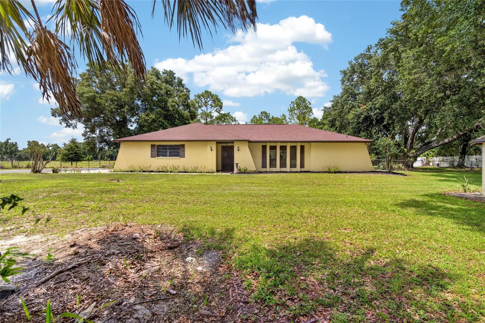 Discover the freedom of no HOA and no deed restrictions with this beautifully updated 4-bedroom, 3-bath pool home offering privacy, space, and a true Florida lifestyle on 1.88 acres. Set back from the road with a stunning paved driveway lined with gorgeous crepe myrtles, this property welcomes you with a beautiful blacktop drive and a peaceful setting with no rear neighbors. The spacious lanai and sparkling pool create the perfect outdoor retreat for entertaining, relaxing, and enjoying the privacy of your own backyard oasis. Inside, the home features a thoughtfully designed split floor plan with no carpet throughout the entire home, creating a clean and easy-care living environment. The gourmet kitchen serves as the heart of the home, offering easy access to the dining room, dinette, and family room while overlooking the expansive lanai and pool through a beautiful view window. The private primary suite provides a relaxing escape with a walk-in closet, sliding doors leading to the pool area, and an ensuite bath with an attached vanity space. Generous secondary bedrooms provide flexibility for family, guests, or a home office, with additional bathrooms conveniently located throughout the home. Bath 3 offers direct access to the pool lanai for added convenience. Additional highlights include a side-load attached garage, interior laundry room, and abundant storage throughout. Enjoy plenty of room to roam, entertain, garden, or simply relax surrounded by privacy and natural beauty. Ideally located with easy access to I-4 from both Exit 17 and Exit 19, this home offers the perfect combination of peaceful acreage living with convenient access to shopping, dining, and nearby amenities. A rare opportunity to own a private pool home on nearly 2 acres with no HOA, no deed restrictions, no rear neighbors, and room to enjoy the lifestyle you’ve been looking for! Call today for your private tour.