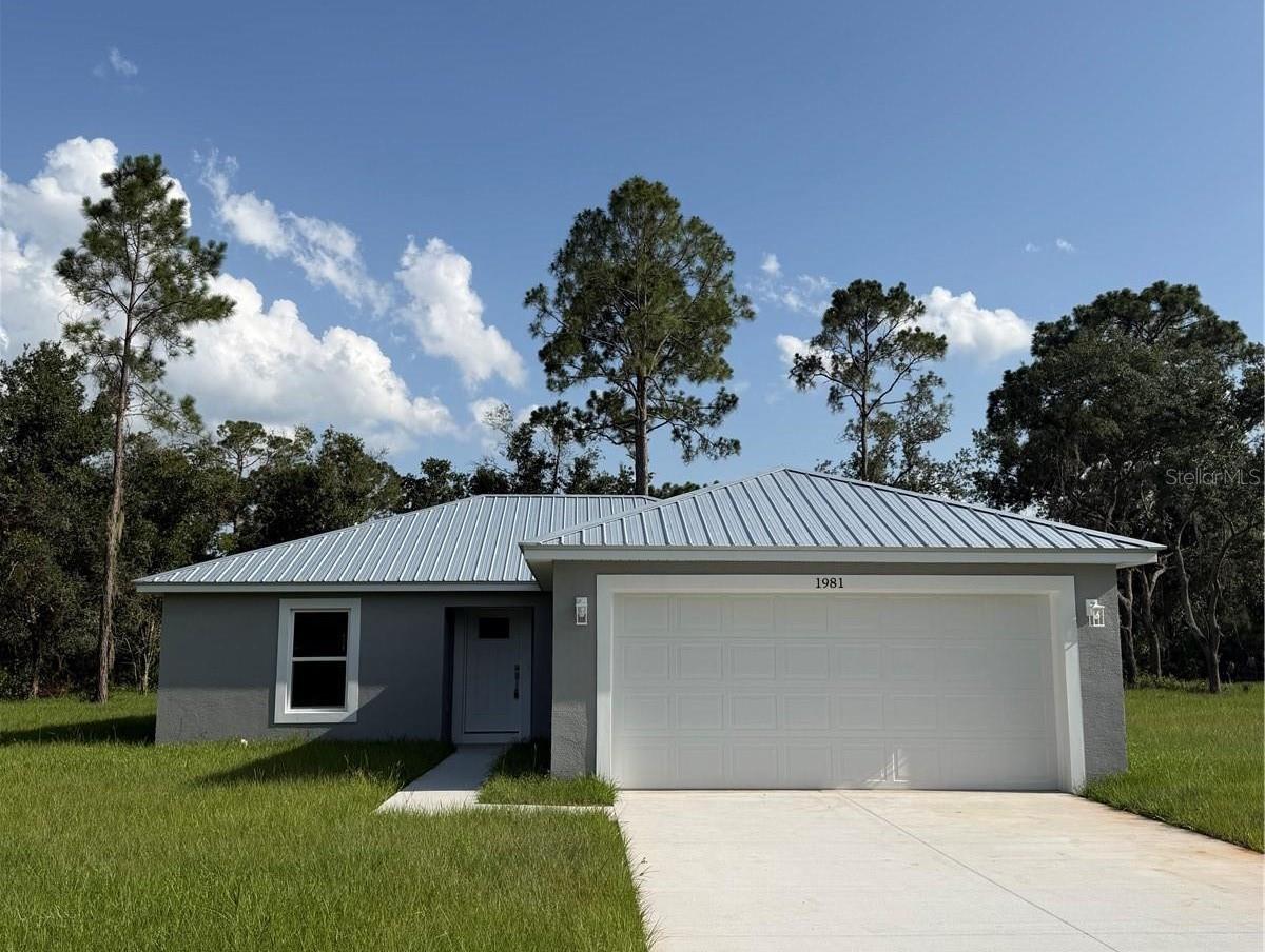 Escape the hustle and bustle of city living and discover this beautiful 3-bedroom, 2-bath home situated on a spacious half-acre lot. Designed with an inviting open-concept floor plan, this home offers the perfect blend of comfort, style, and functionality for everyday living and entertaining. Step inside to find stunning luxury vinyl plank flooring flowing throughout the main living areas, creating a warm and modern feel. The spacious kitchen features gorgeous wood cabinetry, granite countertops, and ample workspace, all overlooking the living and dining areas for seamless gathering and conversation. The split-bedroom layout provides privacy for the primary suite, while two additional bedrooms provide flexibility for family, guests, or a home office. Outside, you'll enjoy the peace and tranquility of country living with plenty of room to relax, garden, or create your own outdoor oasis. If you're looking for modern finishes, open living spaces, and room to spread out just outside the city, this property is one you won't want to miss!