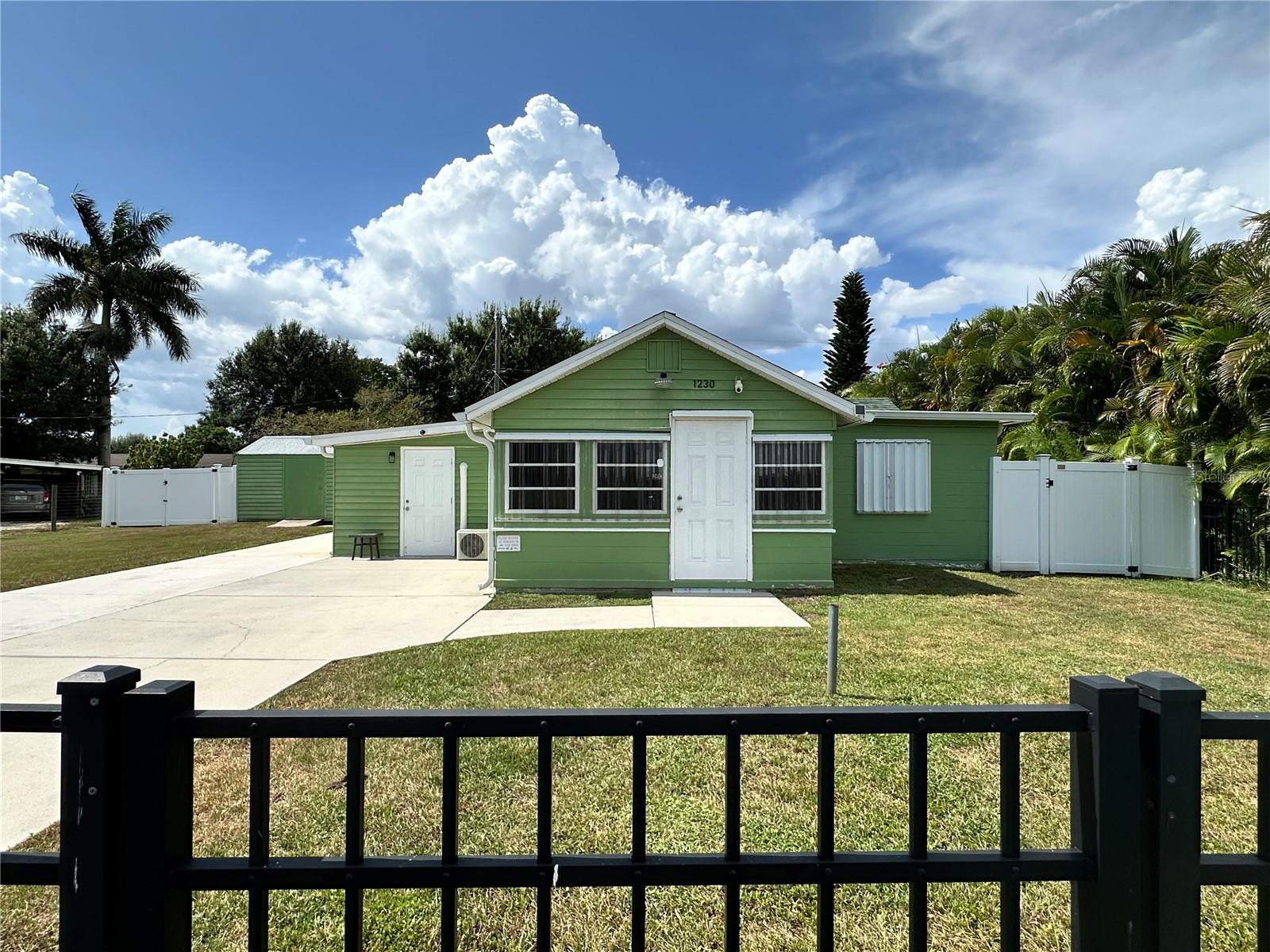 This charming Furnished home is located near the Punta Gorda Airport, Sallie Jones Elementary, Punta Gorda Middle and Charlotte High in Punta Gorda, FL. Just minutes to downtown, dining and shopping AND it is VERY close to the American Legion so you can walk home after cocktails! Property features a black aluminum fence in front of the home with gate and a white 6' vinyl privacy fence in the rear for added privacy. Plenty of storage space in the shed or the bonus space with laundry area that is connected to the home with a private entrance. Perfect for a workshop or hangout or craft area. Bonus space offers an entrance to the kitchen with wood cabinets that is conveniently located next to the living room for easy entertaining. The front room is flooded with sunlight and has a fold out couch so it can be used as a second bedroom. Off of the primary bedroom is a computer area and bathroom with a tub shower combo. Hurricane shutters are in place for added protection and home features a 2023 tankless water heater, 2020 air conditioner and 2019 roof. House generator is powered with propane and there are 2 tanks so you don't run low! Home is being sold furnished so bring your suitcase and your pets to play in the Large back yard!