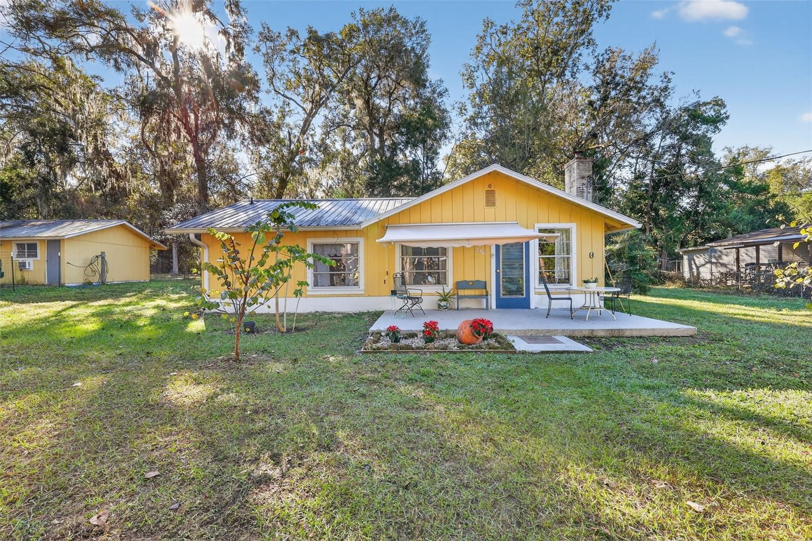 COUNTRY LIVING WITH INCOME POTENTIAL & CLOSE BY RIVER ACCESS! Discover tranquility in this charming 2bd/2bth home (828 sq ft) along with 1bd/1bth Mother-In-Law Suite (320 sq ft) nestled on a spacious, close to half-acre lot in an established peaceful community. Here you will enjoy country living at its best with deeded access to a neighborhood boat ramp leading to the Withlacoochee River, making those afternoon boat rides more possible, plus nearby bike trails for outdoor adventure. This property is the perfect balance of relaxation and recreation without the "river front" price tag. Convenient access to I-75 makes commuting a breeze. Property Features: Detached Mother-In-Law Suite with private entrance offers potential rental/Airbnb income or ideal guest quarters. Many Unique Interior Touches: beautiful antique wood ceilings and a desirable split-floor plan. Country kitchen features a unique, custom-built kitchen with stainless steel industrial counter/sink, functional tile flooring, and a large walk-in pantry closet.  A beautiful remodeled main bathroom is complete, while the second bathroom is set up to be refashioned by the new owner, allowing for personalization. Bonus Feature: second bedroom with a private entrance. Outside Features: Completely fenced yard with mature foliage and beautiful oak trees. Two adequate storage sheds for all your storage needs.  Home and guest house both with durable metal roofs. Outside, relax in the peaceful, fenced yard or on the open patio.  This well-maintained home is move-in ready — no flood zone, no HOA — just freedom to enjoy your space as you wish. Bring your boat, your toys, and your dreams — this slice of Florida is ready for you! Schedule your showing today! SELLER MOTIVATED! No reasonable offer refused!!! For investors: 2 rentals on one property!!!!