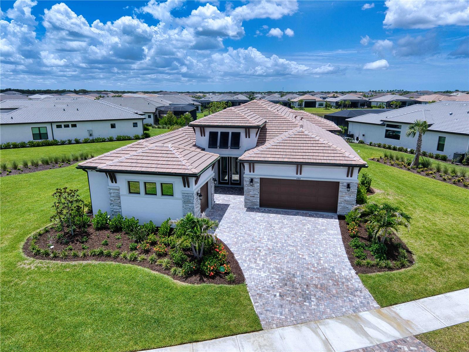 EXCEPTIONAL LUXURY LAKEFRONT LIVING IN ARTISTRY

Experience refined Florida living in this 2025-built lakefront residence, perfectly positioned on an oversized 0.578-acre homesite within the highly desirable Artistry community. This extensively upgraded home combines exceptional design, craftsmanship, and lake views.

The thoughtfully designed floor plan features 3 ensuite bedrooms, a powder room, private office, bonus room, and split 3-car garage with an AC in a two car portion with an expoxy floor. Soaring ceilings, 8-foot doors and custom wood flooring throughout, wood ceiling beams, handcrafted wood plantation shutters, and upgraded interior paint create a warm and elegant atmosphere. Every closet features custom wood shelving, while the primary bedroom closets features a custom wood organization system and pocket doors. Additional enhancements include lighted vanity mirrors in each bathroom, tinted impact-resistant windows and doors, a whole-house water filtration system, gas tankless water heater, and an advanced 8-camera security system.

The gourmet kitchen is a true showpiece, featuring quartz countertops, custom cabinetry, an extended island, two dishwashers, a pot filler above the gas cooktop, and a complete suite of Thermador appliances, including custom built-in column refrigeration and freezer.

The custom-designed, gas-heated pool features lighted water bowls and built-in umbrella sleeves, surrounded by an upgraded paver deck and generous outdoor living areas—all overlooking the tranquil lake. It is an exceptional setting for entertaining, relaxing, and enjoying Sarasota’s year-round indoor-outdoor lifestyle.


Additional upgrades include spray-foam insulation within the block construction for enhanced sound and thermal performance.

Artistry offers a resort-style community lifestyle with amenities including a clubhouse, state-of-the-art fitness center, resort pool, pickleball and walking trails, playground, and beautifully maintenance free community. Ideally located near Lorraine Road and Palmer Boulevard, the community provides convenient access to Downtown Sarasota, Waterside Place, UTC, Lakewood Ranch, championship golf, dining and shopping, cultural attractions, and the renowned Gulf Coast beaches.

This is a rare opportunity to own a nearly new luxury residence offering an extraordinary combination of premium custom upgrades, an oversized lakefront homesite, and resort-style living in one of Sarasota’s most desirable communities.

Schedule your private showing and experience firsthand why this remarkable home truly stands apart.