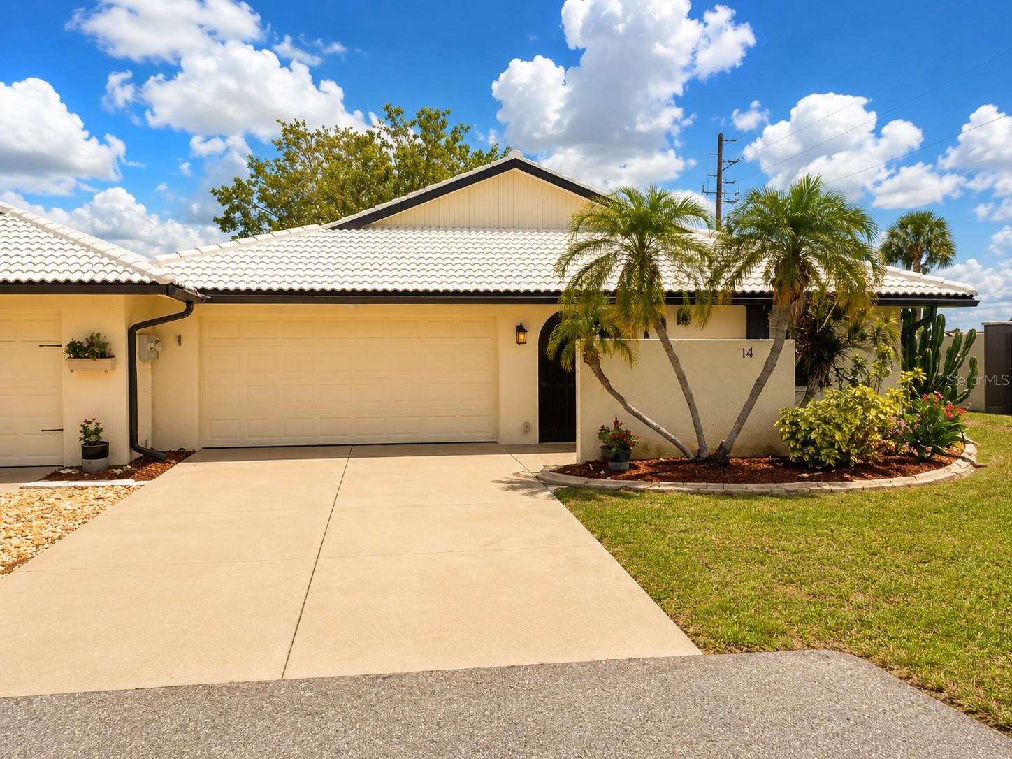 Welcome to effortless Florida living in this beautifully maintained end-unit villa, ideally located in the highly desirable maintenance-free community of Hourglass Lakes. Offering 2 bedrooms, 2 bathrooms, and a spacious 2-car garage, this inviting residence blends comfort, privacy, and convenience with timeless appeal. Vaulted ceilings fill the home with abundant natural light, enhancing the bright and airy atmosphere throughout. The thoughtfully designed split-bedroom floor plan provides ideal privacy for residents and guests alike, the kitchen is both functional and welcoming. Designed for seamless indoor-outdoor living, the open dining and living areas extend to a covered front porch, two screened side patios with privacy walls, and a versatile back room ideal for a home office, hobby room, or peaceful retreat. Residents of Hourglass Lakes enjoy an exceptional lifestyle with resort-style amenities including a clubhouse with library, full kitchen, and gathering space, a heated pool and spa, fitness center, and scenic walking trails surrounding tranquil lakes. Conveniently located in the heart of Venice, this home is just minutes from the beautiful shores of Manasota Key and Venice Beach, the boutique shopping and dining of Downtown Venice Island, and the vibrant attractions of Wellen Park, including restaurants, entertainment, community events, and the Atlanta Braves Spring Training Stadium.