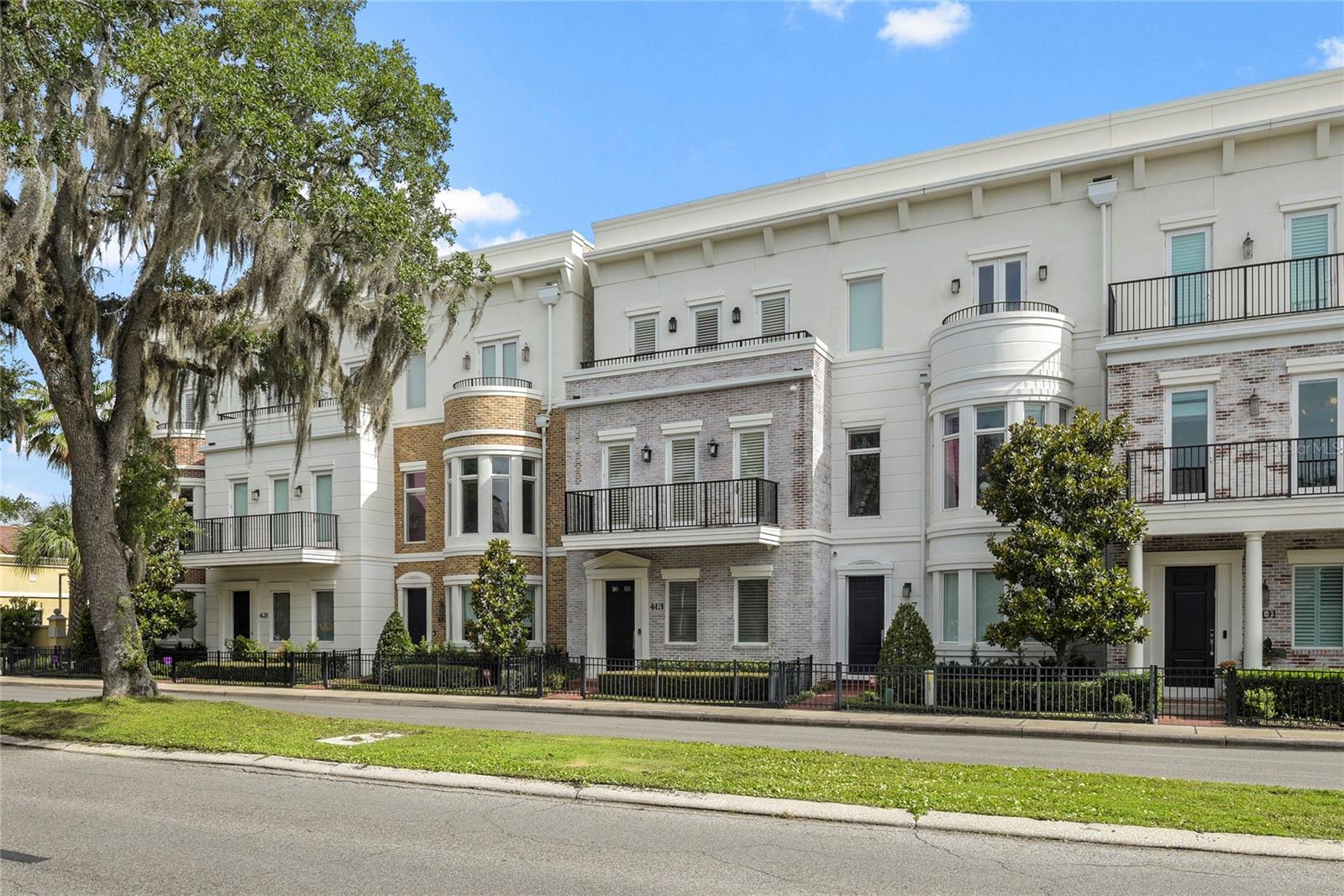 LUXURIOUS LIVING WITH FANTASTIC LOCATION  This Winter Park three story townhouse is within walking distance to all the fun amenities of the city- the many restaurants, boutique shops, banks, post office, farmers market, Central Park and Rollins College. Designed by architect Phil Kean and built in 2017 the owners have embellished this townhome with custom millwork and finishes, wood floors, sound system, full house generator and a private elevator to all floors. The first floor has a two car garage with storage lift above, large laundry room/home office and a downstairs guest suite. The second floor features a stylish and comfortable living room with lovely custom ceiling detail and moldings, gas fireplace, a sophisticated powder bath, and a beautiful dining room that opens to an eat-in chef's kitchen with Subzero, Wolfe and Bosch appliances and light Taj Mahal quartzite countertops. The third floor offers the spacious master bedroom and bath and also has the additional guest bedroom suite. Take the elevator to the roof top for great views of the city and here find even more potential space for fun entertaining. If your dream is to own a townhome in the heart of Winter Park, here is a stunning one for you!