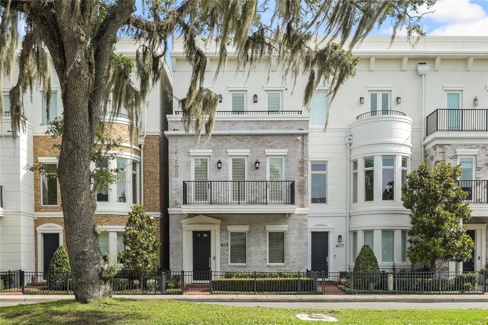 LUXURIOUS LIVING WITH FANTASTIC LOCATION  This Winter Park three story townhouse is within walking distance to all the fun amenities of the city- the many restaurants, boutique shops, banks, post office, farmers market, Central Park and Rollins College. Designed by architect Phil Kean and built in 2017 the owners have embellished this townhome with custom millwork and finishes, wood floors, sound system, full house generator and a private elevator to all floors. The first floor has a two car garage with storage lift above, large laundry room/home office and a downstairs guest suite. The second floor features a stylish and comfortable living room with lovely custom ceiling detail and moldings, gas fireplace, a sophisticated powder bath, and a beautiful dining room that opens to an eat-in chef's kitchen with Subzero, Wolfe and Bosch appliances and light Taj Mahal quartzite countertops. The third floor offers the spacious master bedroom and bath and also has the additional guest bedroom suite. Take the elevator to the roof top for great views of the city and here find even more potential space for fun entertaining. If your dream is to own a townhome in the heart of Winter Park, here is a stunning one for you!