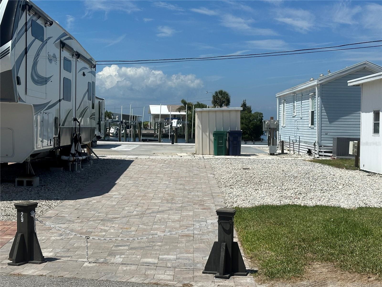 ENJOY THE FLORIDA RV LIFESTYLE IN TROPIC ISLES!  Great opportunity to own a beautifully paved RV lot in Tropic Isles Co-op, a resident-owned 55+ waterfront community known for its active lifestyle, boating amenities, and friendly atmosphere. This RV has been beautifully paved. The low $325 monthly maintenance fee covers water, sewer, garbage, recycling, park management, and access to all community amenities including the marina. Residents enjoy 3 waterfront basins, 2 clubhouses, bait shop, fuel station, boat launch, heated pool & spa, kayak launch and storage racks, plus endless social activities and breathtaking Florida sunsets.  Whether you’re seeking a seasonal getaway or year-round fun, Tropic Isles offers the perfect blend of relaxation, recreation, and community living. Come join the fun!