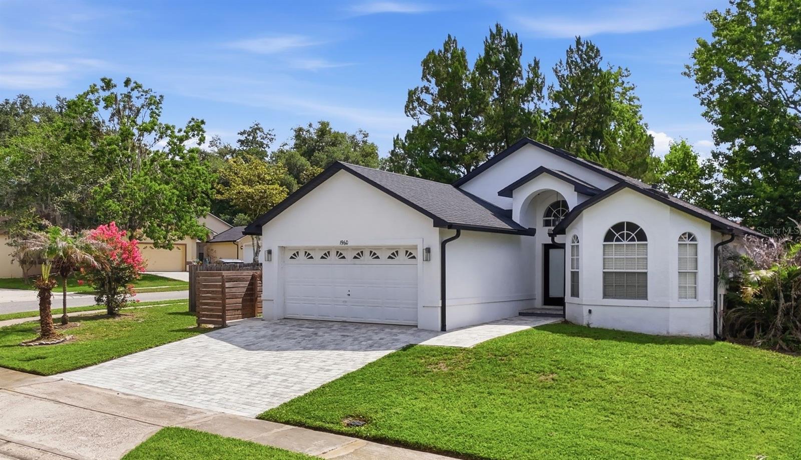 Virtually Staged. Welcome to this beautifully updated 3-bedroom, 2-bath home situated on a desirable corner lot near a quiet cul-de-sac in Riverside at Twin Rivers in Oviedo! Major system updates provide peace of mind, including a newer roof (July 2019), HVAC system (March 2018), and water heater (March 2015). The paver driveway enhances the home's curb appeal, while the fully fenced backyard offers privacy and ample space for outdoor enjoyment.

Step inside to an open and inviting floor plan featuring vaulted ceilings, abundant natural light and luxury vinyl flooring throughout. The spacious family room, dining room, kitchen, and living room flow seamlessly together, creating an ideal setting for both everyday living and entertaining. At the heart of the home is the beautifully remodeled kitchen, thoughtfully designed with white shaker cabinetry, upgraded storage solutions including a spice pull-out and built-in trash drawer, a built-in under-counter microwave, a stainless farmhouse sink, classic white subway tile backsplash and a large quartz island with ample seating.

Thoughtful farmhouse-inspired touches can be found throughout, including updated light fixtures in the foyer and dining room, a large living room ceiling fan, and modern black door hardware. The living room includes a built-in TV mount set up for entertaining and overlooks the backyard through sliding glass doors and an arched window. Outdoor living is equally inviting with an extended paver patio and built-in fire pit creating the perfect space for relaxing evenings and gatherings with family and friends. 

The primary suite features a walk-in closet and an en-suite bath with a garden tub and shower combination. An exterior door from the primary bathroom provides convenient backyard access and offers excellent potential for a future pool bath setup. Both bathrooms have been updated with modern vanities, while the guest bath features a skylight and floor-to-ceiling tile. Additional highlights include multiple storage closets throughout the home, an interior laundry room, a two-car garage, abundant natural light from the arched windows in the front family room, and flexible living space ideal for a sitting area, home office, reading nook, or morning coffee retreat.

Ideally located within Oviedo’s highly rated school district, including Hagerty High School, this move-in ready home offers exceptional convenience to SR 417, shopping, dining, Oviedo on the Park, local trails, UCF, Research Park, Siemens, and Lockheed Martin. Combining style, functionality, and an unbeatable location, this home truly has it all!