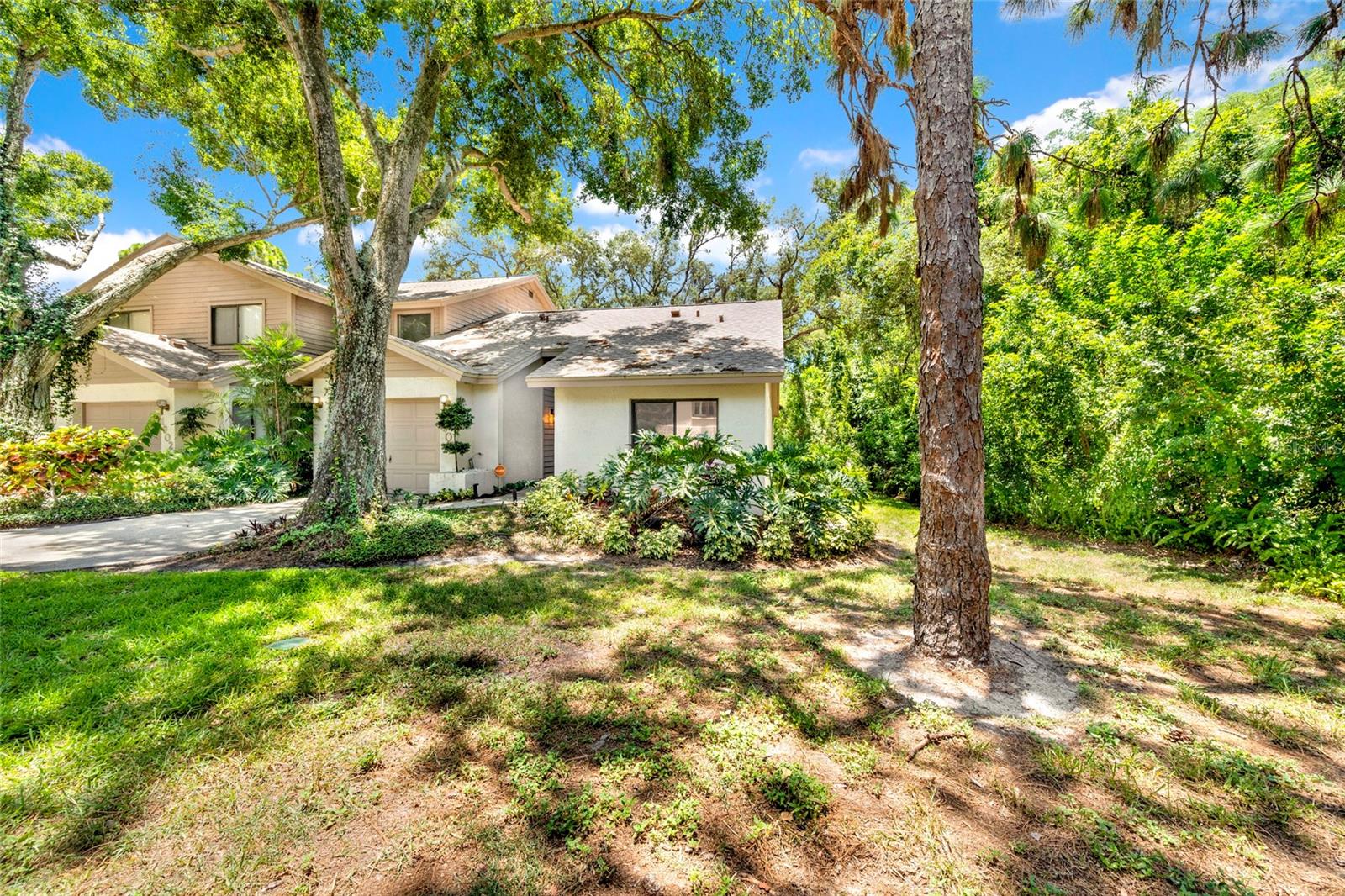 This beautifully updated villa in the highly desirable Whispering Woods community of Tarpon Springs is hitting the rental market today! Nestled on a premium homesite with peaceful pond views, conservation surroundings, and no rear neighbors, this home offers the perfect blend of privacy, comfort, and convenience—just minutes from charming downtown Tarpon Springs, local restaurants, shops, festivals, and Gulf Coast beaches.

Featuring nearly 1,200 square feet of stylish living space that comes furnished or unfurnished, this end-unit villa offers 2 bedrooms, 2 full bathrooms, and a 1-car garage. Inside, you'll find an open-concept floor plan with soaring vaulted ceilings, luxury flooring, updated lighting, and a stunning renovated kitchen complete with real wood cabinetry, granite countertops, designer backsplash, stainless steel appliances, and an oversized breakfast bar perfect for entertaining.

The spacious primary suite features a spa-inspired ensuite bathroom with dual vanities, a walk-in shower with custom tilework, and a walk-in closet. The split-bedroom layout provides privacy, while the secondary bedroom and updated guest bath offer comfort for family members or guests.

Enjoy relaxing pond views from your private balcony accessed through triple pocket sliding glass doors. Residents of Whispering Woods also enjoy access to a community pool, tennis courts, and pickleball courts.

If you're looking for a move-in-ready rental in one of Tarpon Springs' most desirable communities, this is it. Homes like this rarely become available for rent. Schedule your private showing today before it's gone!