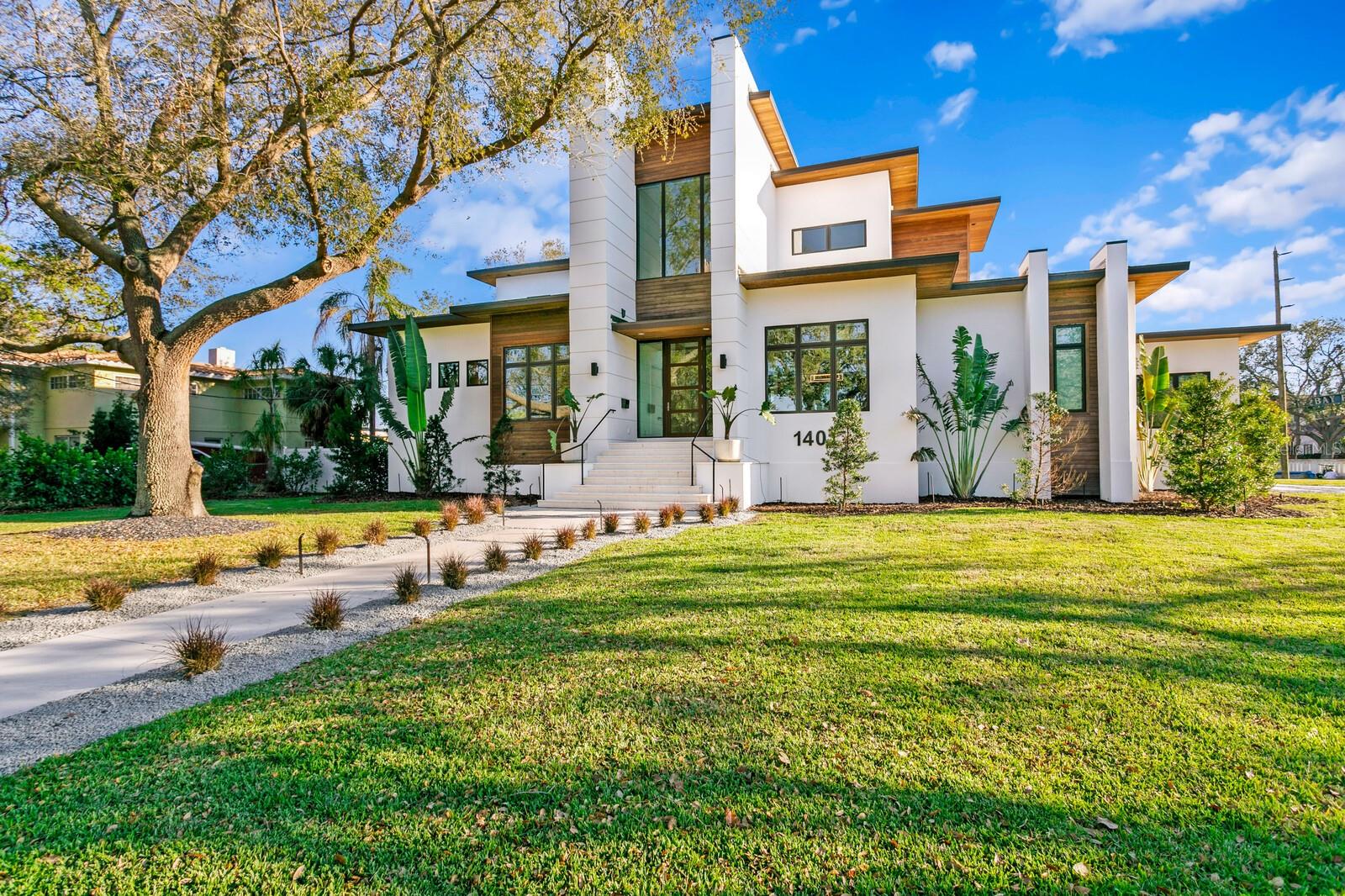 NEW PRICE: Positioned among the BEST VALUES for newer construction luxury waterfront living in Snell Isle. The stunning modern waterfront estate features refined appointments and finishes throughout. Positioned on a large corner lot enjoy water views, a new 125-foot seawall, saltwater pool and floating spa, cabana and outdoor kitchen. A composite dock and 10k boat lift provides access to Tampa Bay. Appointed with IPE Brazilian hardwood throughout a stunning light-filled open floor plan, a gracious open foyer entry invites you to a living room that boasts soaring ceilings (12 foot) and exposed wood beams, statement lighting and expansive sliding glass doors that seamlessly blend the indoor and outdoor living areas. This modern coastal design captivates on the first level that delivers a dramatic floating staircase and formal dining room accented by a wine wall focal feature. An open chef’s kitchen provides for elevated entertaining with dual islands and quartz waterfall countertops, top-of-the-line Wolf and Sub-Zero appliances, full-size Sub-Zero beverage refrigerator, butler’s pantry and additional walk-in pantry. The first level primary suite offers a true escape that includes a sitting area and expansive window wall, automated shades, dual custom walk-in closet, laundry and spa-inspired bath that exudes elegance in the floating his/her vanities and a marble wet-room with soaking tub. Additional first level living areas include an inviting breakfast area with floor-to-ceiling windows, office, powder bath, laundry room and mudroom. Transition to the second level via an elevator or staircase to the media-ready open great room that offers terrace access via expansive sliding glass doors, along with three generous ensuite guestrooms. Additional appointments include a dog-wash station in the expanded laundry room, 24KW Generator, tankless water heater, water purification system, 4-car garage. Enjoy expansive terraces, numerous covered entertaining areas manicured grounds and irrigation system. Located near the Vinoy Golf Club and Downtown St. Petersburg, enjoy easy access to parks, shopping, dining, and recreation both on and off the water. Experience exceptional waterfront living with convenient access to award-winning beaches—built to elevated standards in one of St. Petersburg’s most sought-after neighborhoods.
