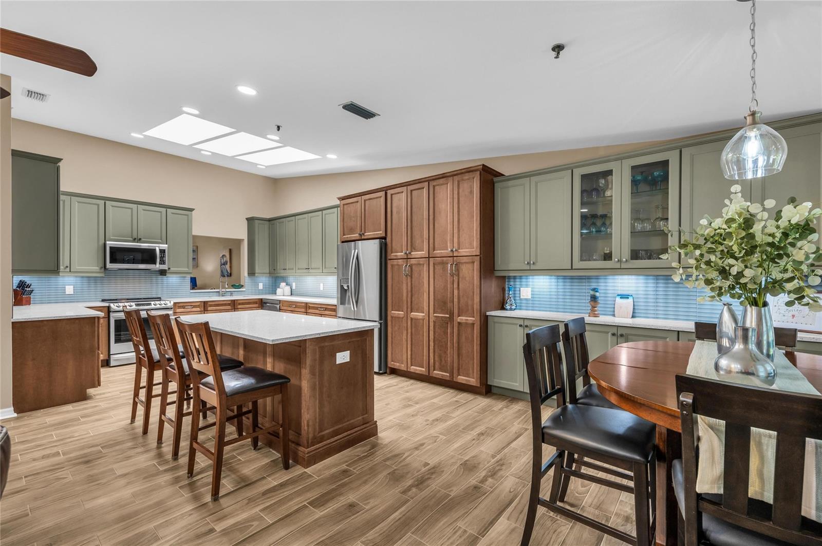 Move right in and start enjoying the Longboat Key lifestyle! Perfectly positioned behind the gates of highly sought after Bay Isles, this beautifully renovated residence combines elegant updates, low-maintenance living, and one of the area's most desirable resort-style communities. Every major improvement has already been completed, allowing you to simply unpack and begin enjoying paradise. The thoughtfully redesigned kitchen is the heart of the home, featuring all-new appliances, a wine refrigerator, custom all-wood cabinetry with convenient pull-out shelving, and an open design that flows effortlessly into the spacious living and dining areas. New tile flooring extends throughout the kitchen, living room, and primary suite, while new carpet creates warm, inviting guest bedrooms. The impressive list of recent upgrades provides exceptional peace of mind, including a new tile roof with hurricane-rated skylights, hurricane-impact windows and doors, new HVAC system with UV air purification lights, tankless water heater, water softener, new garage door opener, fresh interior paint throughout, and beautiful plantation shutters installed throughout the home. One of the home's most outstanding features is the enormous private screened lanai, creating an exceptional outdoor living space rarely found in this price range. Complete with an awning for covered grilling and tranquil pond views, this oversized outdoor retreat is perfect for morning coffee, afternoon relaxation, entertaining friends, or enjoying Florida's spectacular sunsets. A charming garden patio, accessible from both the guest bedroom and laundry room brings in the Florida sunlight and a place to grow tropical plants or a private herb garden. Ownership in Bay Isles includes exclusive access to the private Bay Isles Beach Club, where residents enjoy deeded Gulf-front beach access complete with gated parking, pavilions, picnic facilities, grills, restrooms, and miles of Longboat Key's world-famous white sand beaches. Flood insurance is conveniently included within the HOA fees, providing additional value and peace of mind. Just minutes away, the Longboat Key Moorings Marina offers deep-water boating accommodations, waterfront dining, and one of the Gulf Coast's premier marinas. Residents also have the opportunity to apply for membership at the renowned Longboat Key Club, featuring championship golf, world-class tennis and pickleball, resort pools, spa facilities, fitness centers, private beach amenities, and exceptional waterfront dining. Beyond the gates, enjoy the sophisticated coastal lifestyle that makes Longboat Key one of Florida's most sought-after destinations. Discover award-winning restaurants, waterfront dining, boutique shopping, art galleries, and charming cafés throughout Longboat Key, while nearby St. Armands Circle and Lido Key offer additional upscale shopping, fine dining, entertainment, and beach experiences just a short drive away. Downtown Sarasota's vibrant arts, theater, and cultural attractions are also conveniently close. Whether you're searching for a year-round residence, seasonal retreat, or luxurious lock-and-leave home, this extensively updated Bay Isles residence offers an exceptional combination of quality, comfort, location, and resort-style amenities that is truly difficult to match.