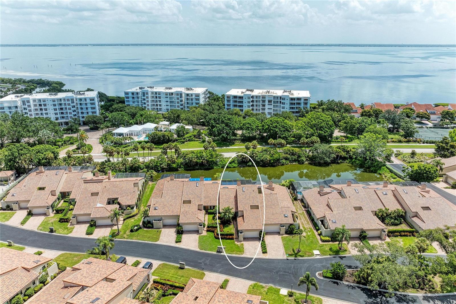 Move right in and start enjoying the Longboat Key lifestyle! Perfectly positioned behind the gates of highly sought after Bay Isles, this beautifully renovated residence combines elegant updates, low-maintenance living, and one of the area's most desirable resort-style communities. Every major improvement has already been completed, allowing you to simply unpack and begin enjoying paradise. The thoughtfully redesigned kitchen is the heart of the home, featuring all-new appliances, a wine refrigerator, custom all-wood cabinetry with convenient pull-out shelving, and an open design that flows effortlessly into the spacious living and dining areas. New tile flooring extends throughout the kitchen, living room, and primary suite, while new carpet creates warm, inviting guest bedrooms. The impressive list of recent upgrades provides exceptional peace of mind, including a new tile roof with hurricane-rated skylights, hurricane-impact windows and doors, new HVAC system with UV air purification lights, tankless water heater, water softener, new garage door opener, fresh interior paint throughout, and beautiful plantation shutters installed throughout the home. One of the home's most outstanding features is the enormous private screened lanai, creating an exceptional outdoor living space rarely found in this price range. Complete with an awning for covered grilling and tranquil pond views, this oversized outdoor retreat is perfect for morning coffee, afternoon relaxation, entertaining friends, or enjoying Florida's spectacular sunsets. A charming garden patio, accessible from both the guest bedroom and laundry room brings in the Florida sunlight and a place to grow tropical plants or a private herb garden. Ownership in Bay Isles includes exclusive access to the private Bay Isles Beach Club, where residents enjoy deeded Gulf-front beach access complete with gated parking, pavilions, picnic facilities, grills, restrooms, and miles of Longboat Key's world-famous white sand beaches. Flood insurance is conveniently included within the HOA fees, providing additional value and peace of mind. Just minutes away, the Longboat Key Moorings Marina offers deep-water boating accommodations, waterfront dining, and one of the Gulf Coast's premier marinas. Residents also have the opportunity to apply for membership at the renowned Longboat Key Club, featuring championship golf, world-class tennis and pickleball, resort pools, spa facilities, fitness centers, private beach amenities, and exceptional waterfront dining. Beyond the gates, enjoy the sophisticated coastal lifestyle that makes Longboat Key one of Florida's most sought-after destinations. Discover award-winning restaurants, waterfront dining, boutique shopping, art galleries, and charming cafés throughout Longboat Key, while nearby St. Armands Circle and Lido Key offer additional upscale shopping, fine dining, entertainment, and beach experiences just a short drive away. Downtown Sarasota's vibrant arts, theater, and cultural attractions are also conveniently close. Whether you're searching for a year-round residence, seasonal retreat, or luxurious lock-and-leave home, this extensively updated Bay Isles residence offers an exceptional combination of quality, comfort, location, and resort-style amenities that is truly difficult to match.