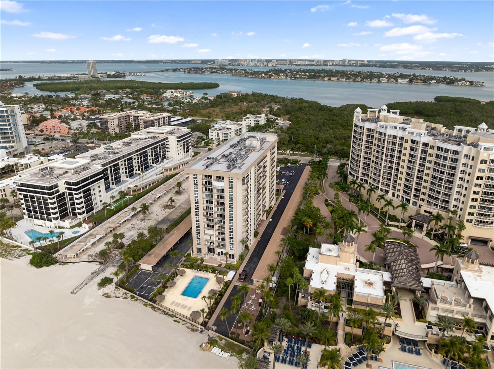 Great price reduction and motivated seller. Unforgettable. Unmatched. Unrivaled. Welcome to Lido Beach Club. From the moment you step inside this spectacular, beautifully updated 2nd-floor residence, you’ll feel as though you’ve arrived at your own private luxury suite and on a permanent vacation. The instant you enter, an explosion of blue skies, turquoise waters, and endless coastline greets you, creating a front-row experience of Sarasota’s most breathtaking sunsets. This home doesn’t just impress—it absolutely captivates.

Every detail of this 1,421-square-foot residence has been elevated to capture the essence of luxury coastal living. The A/C system and water heater were replaced just last year, giving you immediate peace of mind, while the open, airy layout pulls your eyes straight to the sweeping Gulf views that define every room. The kitchen feels like it belongs in a five-star resort. Solid wood cabinetry pairs with rich granite countertops, tiled backsplashes, and sleek stainless-steel appliances to create an atmosphere that is both elegant and energizing. It’s the perfect setting for morning coffee, evenings with friends, or simply admiring the beauty of the shoreline from your own dining space.

The two bedrooms each offer a magical, immersive experience with floor-to-ceiling windows that make the Gulf feel close enough to touch. Both en-suite bathrooms have been transformed into spa-level retreats, featuring exquisite tilework, seamless glass showers, and refined, modern finishes that elevate your daily routine into something extraordinary. This is where luxury meets serenity—every moment feels indulgent.

Step onto the private balcony and let the warm Gulf breeze wrap around you as you take in wide, unobstructed water views framed by classic wrought iron detailing. It’s a picture-perfect vantage point, complete with a charming glimpse of the Ritz-Carlton Beach Club next door, reminding you that you’re living at one of the most coveted addresses on the entire coastline.

Life at Lido Beach Club feels like being on permanent vacation. The building is expertly managed and offers resort-style amenities designed for relaxation and enjoyment. A heated beachfront pool with tropical Tiki seating creates a dreamy setting for quiet afternoons. A serene garden provides moments of calm, while a well-equipped fitness room and a welcoming social room give residents beautiful spaces to connect and unwind. Gated access leads directly to the silky sands of Lido Beach, and convenient assigned parking with additional ground-floor storage ensures effortless everyday living.

The location is simply phenomenal. Nestled on the exclusive south end of Lido Key, the residence is steps from the water, across from the lush natural beauty of South Lido Park, and next door to the iconic Ritz Tiki Bar. St. Armands Circle—with its world-famous shopping, dining, and entertainment—is just one mile away, and vibrant downtown Sarasota is only a quick ride via the free Bay Runner trolley.

This home is more than a coastal retreat; it’s a daily invitation to live life inspired. Luxury, beauty, and the magic of Sarasota’s waterfront come together in a way that feels truly extraordinary. This is your chance to embrace the Sarasota lifestyle at its absolute finest.