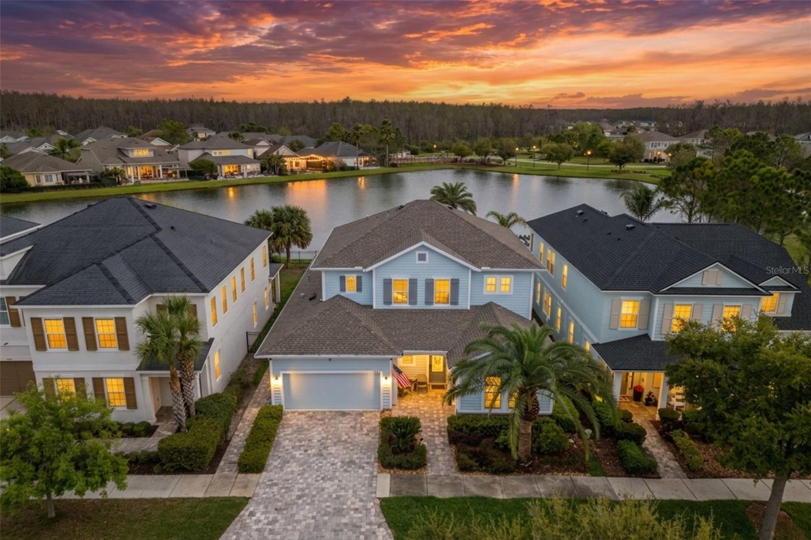 Former model homes rarely become available in Asturia, and this Mendocino floor plan shows exactly why they are so desirable. Filled with builder upgrades and overlooking one of the community’s main ponds, the home offers a thoughtful layout, distinctive architectural details, and an outdoor living space designed to take full advantage of the view. Just inside the entry, a first-floor bedroom and full bathroom create a comfortable and private space for guests. Farther into the home, a flexible office or workspace adds even more versatility before the floor plan opens into the main living area. The kitchen, dining room, and living room come together in one spacious, open setting that works equally well for everyday living and entertaining. A dramatic two-story ceiling gives the dining area an impressive sense of scale while bringing in an abundance of natural light. The living room is anchored by a stone accent wall and offers a direct view of the pool and pond beyond. The kitchen features custom cabinetry, under-cabinet lighting, built-in appliances, a gas cooktop, and a large center island with plenty of room for seating and gathering. Outside, the backyard is set up for enjoying the Florida lifestyle. The spool can be used as both a pool and spa and is complemented by water features, paver decking, and a full outdoor kitchen. The peaceful pond backdrop makes the space feel private and relaxing. The first-floor primary suite is located just off the living area and includes coffered ceilings, pond views, and a spacious en suite bathroom with dual vanities, a large walk-in shower, and a walk-in closet. Upstairs are two additional bedrooms, a full bathroom, and a flexible bonus area that can serve as a media room, playroom, or second living space. A finished walk-in attic provides valuable additional storage. Located in the highly desirable Asturia community in Odessa, the home is just a short walk from the resort-style amenities, including the clubhouse, fitness center, community pool, dog park, playground, and miles of scenic walking trails. With convenient access to the Suncoast Parkway, shopping and dining along State Road 54, and highly rated schools, Asturia remains one of the most sought-after communities in the Tampa Bay area.