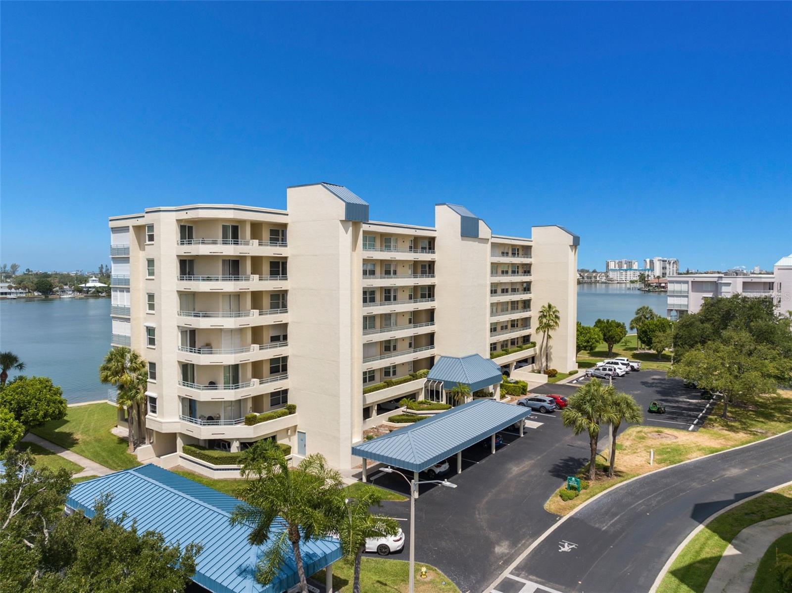 “BEACHWALKER” -Most desirable location in all of Harbourside— resort style living in one of South Pasadena’s finest waterfront communities. An immaculate, beautifully maintained, DIRECT WATERFRONT 2-bedroom 2- bath has been thoughtfully updated and cared for, providing comfort and quality. Plenty of natural daylight. West facing balcony with beautiful sunset views, enhanced by new gemstone floor coverings and protected with hurricane impact windows and electric shutters on both the balcony and master bedroom— (shutter motor updated in 2023).
Unit features newer stainless-steel appliances, updated ceiling fans and light fixtures, plantation shutters on all windows and the balcony, solid surface kitchen counters, and a granite vanity top in the primary bath. Additional upgrades include newer garbage disposal, kitchen faucet, and custom shelving in all closets. The AC (2019) and hot water tank (12/2022) ensure efficient, reliable performance. Convenient under building assigned parking space #94. Complete Elevator modernization in 2025. A gated community with Exceptional amenities including Swimming pools and Spa's, EV charging stations, pickleball courts, tennis courts, shuffleboard, an active clubhouse, and miles of waterfront walking paths. Boat slips, guest boat docks (available on a first come-first serve) fishing pier, and a rare opportunity to own a pristine unit in a vibrant, amenity rich waterfront, community—perfect for full-time coastal living. Just minutes to the finest GULF Beaches. Oh, and a pet friendly community. Perfect timing to send out invites for the Pasadena Christmas boat parade that passes by right in front of your balcony. 
In addition, this unit is sold with a full wall media cabinet/bookcase with electric remote-control fireplace, plus a kitchen dinette table and 2 chairs. A MUST SEE! Schedule your showing.