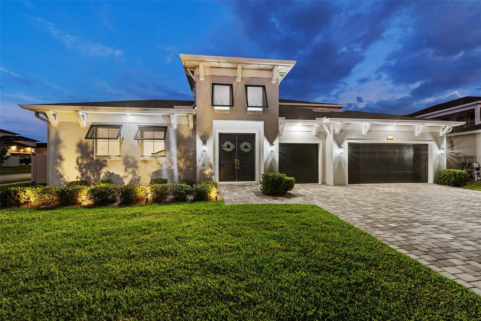 Welcome to this exceptional residence in the exciting Wesley Chapel area, and conveniently in the sought-after Epperson Lagoon Community. This six-bedroom, 5.5-bath, three-car garage home offers an impressive blend of luxury, functionality and modern design. Enter through the elegant French doors into a beautiful courtyard with screened-in patio, and beautiful saltwater pool. Upon entering the home there is a spacious open-concept floor plan, where the expansive living room serves as the heart of the home, and features built-in surround sound for an enhanced entertainment experience. Designed with everyday living and entertaining in mind, the dining area overlooks the pool and patio through ample sliding glass doors. The professionally designed kitchen features quartz countertops, an oversized island with sink, stylish custom tile backsplash, motion-activated under-cabinet lighting, built-in smart dual convection ovens, induction cooktop, stainless steel appliances and a large walk-in pantry with built-in storage. The luxurious primary suite offers direct pool access through sliding glass doors with an electric shade, dual walk-in closets, separate dual vanities, an oversized walk-in shower with dual shower heads and glass enclosure, along with abundant natural light. Moving upstairs, a spacious loft opens to a private balcony, creating a flex space for entertaining or relaxation. This thoughtfully designed home features two upstairs en-suite bedrooms, each with a walk-in shower, plus two additional downstairs bedrooms connected by a Jack-and-Jill bath. A private in-law suite offers exceptional multigenerational living with its own full bath, kitchenette and separate security system. Additional features include a water softener and reverse osmosis system, extra paver patio outdoor area, each bedroom has an en-suite bath, and the upstairs loft features pre-plumbing for a wet bar. This growing area is home to the sought-after Innovation Preparatory Academy and The Kirkland Ranch Academy of Innovation schools, plus a new Publix, Starbucks and Chick-fil-A, while also conveniently minutes from Interstate 75 providing ample shopping and dining options at Tampa Premium Outlets, Shops at Wiregrass, and The Grove & KRATE.