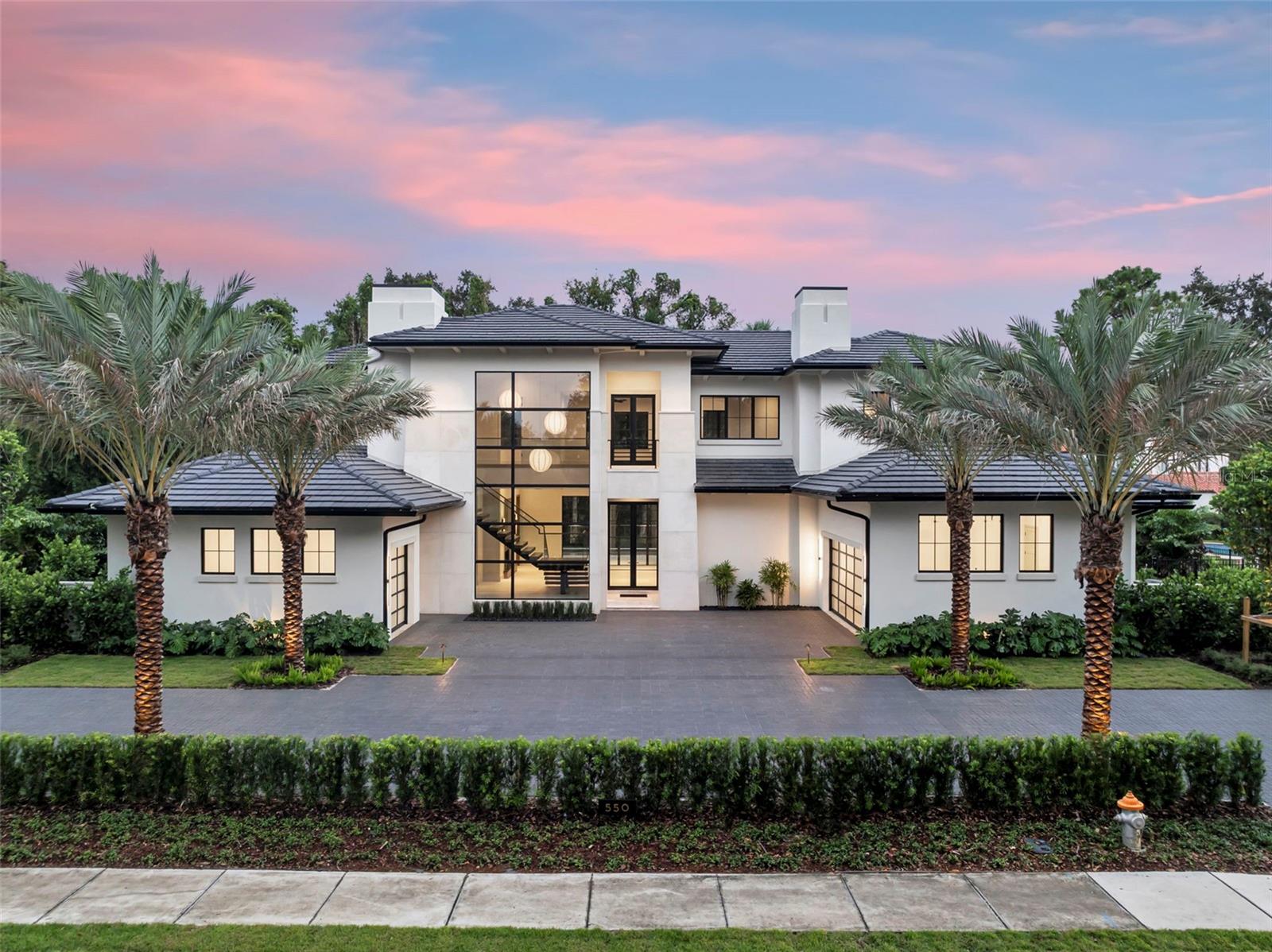 Exquisite new construction with 5 Bedrooms  6.5 Baths and a 3 car garage, in the Heart of Winter Park perfectly positioned on an oversized lot just steps from Park Avenue’s renowned shops, fine dining, and the iconic Winter Park 9-hole golf course, this extraordinary custom residence is a showcase of timeless design and modern luxury. Conceived by acclaimed architect Dan Delong of Origins Residential Design and brought to life by Sean Wulff of Native Homes, every detail has been thoughtfully curated to impress even the most discerning buyer. The expansive floor plan encompasses 5 bedrooms, 6 full baths, and 1 half bath, blending sophistication and comfort across multiple living spaces. Highlights include a dramatic great room, inviting family room, private study, downstairs guest suite, a full bar featuring a 56-bottle wine refrigerator, and an upstairs game room ideal for both everyday living and elegant entertaining. A grand entry reveals the great room with soaring floor-to-ceiling windows and elegant Italian porcelain tile, all overlooking the serene pool and patio. The chef’s kitchen seamlessly connects to the family room and features Canadian-crafted European-style cabinetry, Wolf, Sub-Zero & Fisher & Paykel appliances (dual ovens, dual dishwashers, built-in coffee maker, wine cooler, and beverage center), quartzite countertops, a large island with bar seating, hidden walk-in pantry, plus whole house water softener and filtration systems for premium convenience. The first-floor primary suite is a true retreat with spa-inspired amenities and a custom-built walk-in closet complete with cabinetry and a spacious island. Also on the main level: a private guest suite and dedicated home office/study. Upstairs, a generous game room and three additional en suite bedrooms provide comfort and privacy for family and guests alike. Designed for seamless indoor-outdoor living, the residence boasts two covered lanais finished in Turkish Marble, disappearing screens, a summer kitchen with Urban Bonfire Cabinetry, refrigerator, and ice maker, along with a freestanding fire pit and lush tropical landscaping. The saltwater pool with sun shelf and heated gas spa ensures year-round enjoyment. Built to the highest standards, the home features R-14 block walls with core 500 insulation, open cell foam insulation in attic, Andersen windows, a flat concrete tile roof, and tongue-and-groove ceilings on all lanais. Additional luxuries include:
Select European white oak wood floors and Italian porcelain flooring throughout
12’ ceilings on the main level, 10’ ceilings upstairs
Cutting-edge construction for efficiency and durability