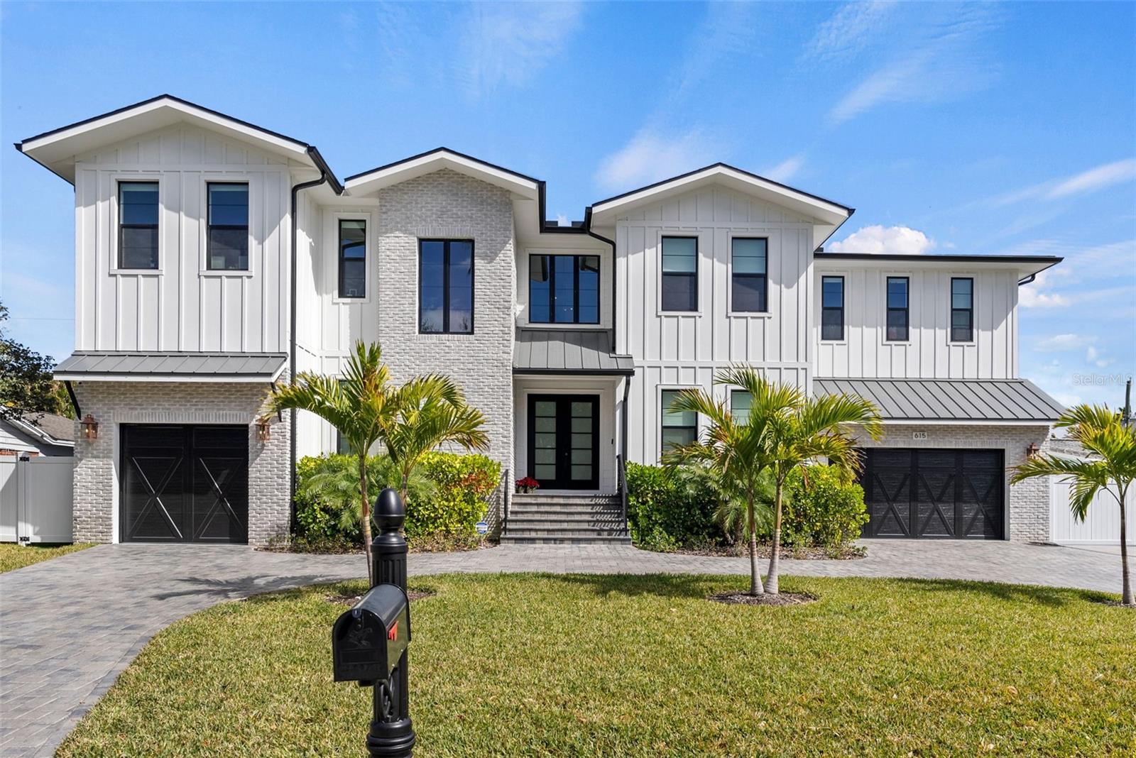 Highly sought-after Davis Islands newer construction by TB Homes offering over 5,700 square feet of air-conditioned living space with 5 bedroom suites, including a first-floor guest suite, 2 powder baths, and a rare 3-car garage configuration (2-car + separate 1-car). Thoughtfully designed for both everyday comfort and elevated entertaining, the home features a private office/study, dedicated gym, first-floor playroom or flex space, spacious media room with kitchenette, formal dining room, expansive great room, eat-in chef’s kitchen with oversized island, walk-in pantry, and a functional mudroom/drop zone.

The luxurious second level includes a generous primary suite with spa-inspired bath, multiple walk-in closets with custom built-ins, loft space, and well-appointed secondary bedroom suites, creating ideal separation and flexibility for family or guests. Custom closet systems are installed throughout both the first and second floors. A shaft for a future elevator extends from base grade through both floors for long-term convenience.

The fully enclosed backyard is a private resort featuring a saltwater heated pool and spa, silver travertine decking, low-maintenance turf green space, a mosquito misting system, and a covered lanai with outdoor kitchen—perfect for year-round Florida living.

Built with quality and durability in mind, construction highlights include two-story concrete block construction, Hardie board concrete siding, brick accents, impact-rated windows and doors, and elevated design standards throughout. Interior finishes showcase wide-plank oak flooring, smooth drywall, detailed millwork, custom cabinetry, Sub-Zero/Wolf appliances, and designer marble and porcelain tile in all wet areas.

Modern convenience and technology are fully integrated with whole-house WiFi, a comprehensive AV system with distributed speakers throughout the home, a whole house water filtration system, and a full-house generator for peace of mind and uninterrupted comfort.

Located on beautiful Davis Islands, enjoy walkability and golf-cart access to village shops and dining, waterfront parks, bike paths, tennis courts, dog parks, marina, beach, and the historic public pool—just minutes to Downtown Tampa, Water Street, Sparkman Wharf, Tampa General Hospital, and the Riverwalk, with convenient access to Tampa International Airport.