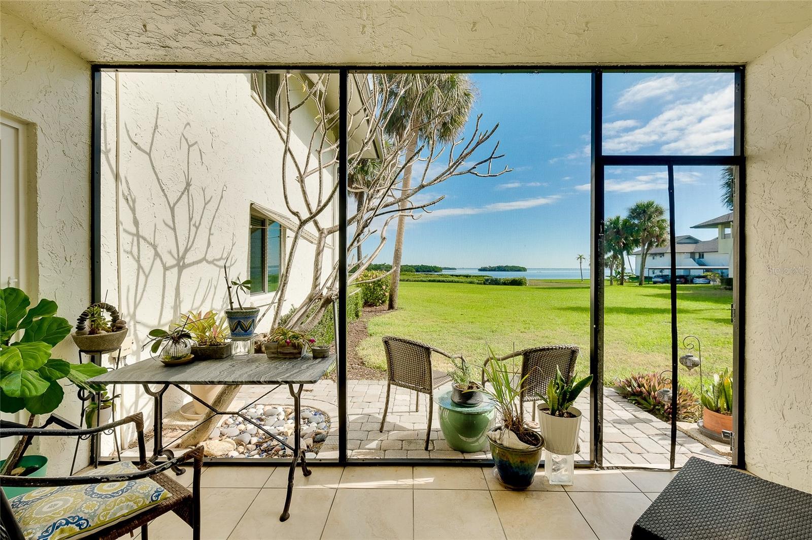 Is it possible to say that there is a “BEST’ location on Longboat Key?  If sunrises over the Bay from your comfy chair captivate you….. if striking sunsets on the beach, over the Gulf waters leave you mesmerized…. If short strolls with your pooch to the local paw-park are a favorite part of your daily routine….. or if launching your kayak/ paddleboard or loading up the boat for a stressless day on the water are what you look most forward to…… then yes!  There is a BEST place and it is called Pelican Harbour.  Amenity rich and located mid-key, you can do all of this and so much more.  Piece of mind is another attribute of this ground floor 2bed/2bath home on the quiet north side of the community because it remained completely dry and unharmed during the storms of 2024- not a drop of water intrusion here!  Qualities of this home include impact windows and sliders, consistent tile floor throughout, full size in-unit washer/dryer, whole home water filtration system, plantation shutters and updated baths both with walk-in showers.  Pelican Harbour is aesthetically pleasing with a leisurely vibe.   Excellent thought and care were put into the recently updated clubhouse, pool furnishings, bayfront sitting dock and landscaping as well as new roofs, hurricane safe carports, tennis and pickleball courts and boat docks.  We are pet-friendly and there are currently boat docks available for a very reasonable annual fee.