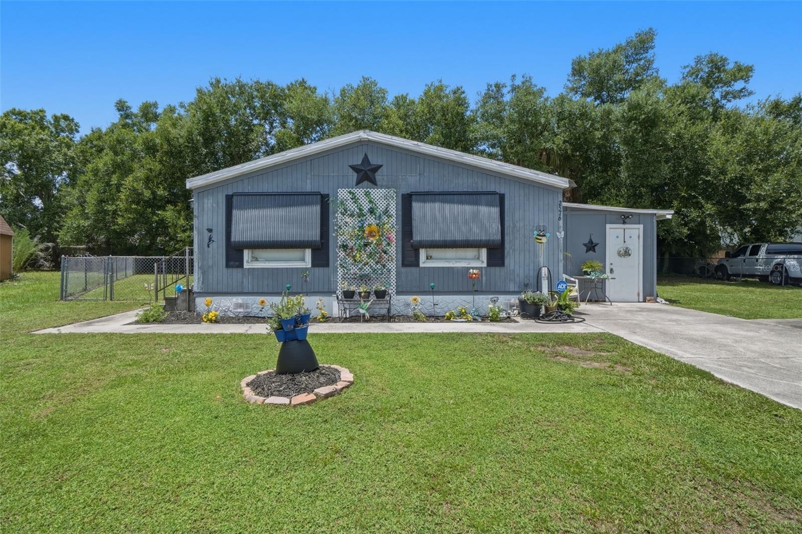 Opportunity Knocks in Saint Cloud!

Discover the potential of this spacious double-wide manufactured home situated on owned land—with NO HOA and NO lot rent—in a quiet, established neighborhood. Offering 2 bedrooms, 2 full bathrooms, and a versatile Florida room that can serve as a home office, hobby space, or additional living area, this property is full of possibilities.

With over 1,000 square feet of living space, this home provides the perfect canvas for investors, first-time homebuyers, or anyone looking to personalize a home to fit their style. The fully fenced backyard offers privacy and ample space for entertaining, gardening, pets, or future outdoor enhancements. A covered carport and paved driveway provide convenient off-street parking.

Enjoy the best of Saint Cloud living just minutes from Historic Downtown Saint Cloud, where you'll find charming boutiques, local restaurants, seasonal events, and a welcoming community atmosphere. Outdoor enthusiasts will love the nearby Lakefront Park on the shores of East Lake Tohopekaliga (Lake Toho), featuring a public marina, boat ramps, fishing pier, walking and biking trails, playgrounds, picnic pavilions, splash pad, sandy beach, and scenic waterfront views.

Additional nearby amenities include shopping centers, grocery stores, schools, medical facilities, and recreational parks. Commuters will appreciate the easy access to Florida's Turnpike, placing Kissimmee, Lake Nona, Orlando International Airport, and Downtown Orlando within convenient reach.

Whether you're searching for your next investment opportunity, a renovation project, or an affordable place to call home, this property offers exceptional value, endless potential, and an unbeatable location.