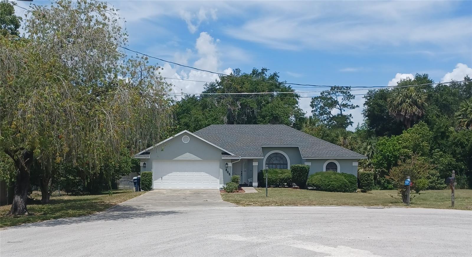 This 3/2 custom built home is located at the end of a Cul- de-sac with NO HOA. NO rear neighbors & spacious back yard offers many possibilities- add a pool, workshop, shed.  Split floor plan w/ primary bedroom ensuite bathroom- tiled walk in shower & walk in closet. 3rd bdrm & living room have french doors that open to the glassed in lanai. Cathedral ceiling in  living room. Inside laundry w/ door that opens into garage with garage actually having a side door, Conveniently located short distance to downtown Tavares (golf cart friendly community), Chain of Lakes, YMCA, shopping, dining, hospital & other medical care.  Easy to show.