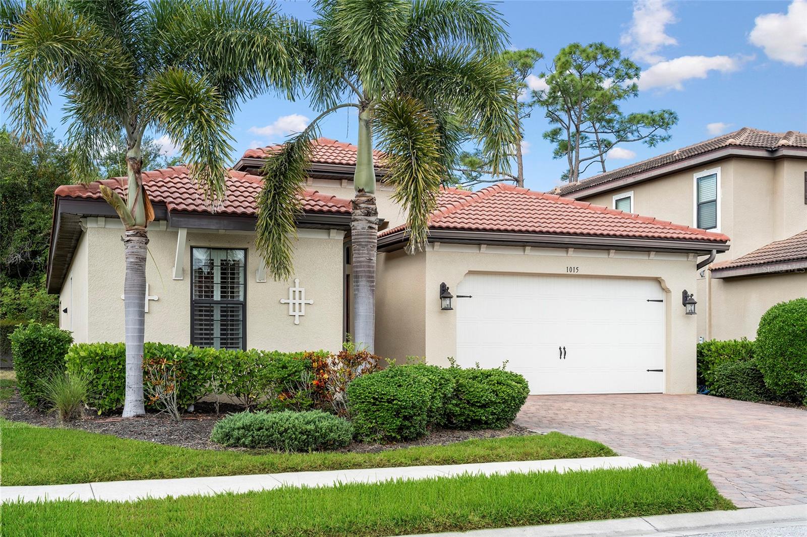 Welcome to this beautifully maintained Pembroke model in the highly sought-after gated community of Calusa Park. Offering over 1,800 square feet of living space, this 3-room, 2-bathroom home combines comfort, style, and the best of Florida living.

From the moment you arrive, you'll appreciate the extra-wide driveway and impressive Foxtail palms that create outstanding curb appeal. Inside, the open split-bedroom floor plan is enhanced by large tile flooring throughout the main living areas, plantation shutters, crown molding, and elegant tray ceilings. Generous closet space provides plenty of storage and organization.

The heart of the home is the spacious great room that flows seamlessly into the well-appointed kitchen, featuring granite countertops, solid wood cabinetry with under-cabinet lighting, and a convenient pantry. A whole-house surge protector adds an extra layer of protection and peace of mind.

Step outside to the paver lanai and enjoy your own private backyard retreat, ideal for entertaining, outdoor dining, or simply relaxing in the Florida sunshine. The yard offers ample space to add a pool, allowing you to create your dream outdoor oasis.

The two-car garage features an epoxy-coated floor and an emergency backup electrical panel for a generator. Located in the maintenance-free community of Calusa Park, residents enjoy access to a heated community pool and cabana, all with low HOA fees and no CDD fees.

Why wait months for new construction when you can move into a meticulously cared-for home today without the delays, upgrades, and additional costs that often come with building? Conveniently located between charming Venice and vibrant Sarasota, Calusa Park provides easy access to U.S. 41, I-75, area beaches, historic downtown Venice, and the renowned Legacy Trail, where you can enjoy miles of scenic biking, walking, and running trails right from your community.