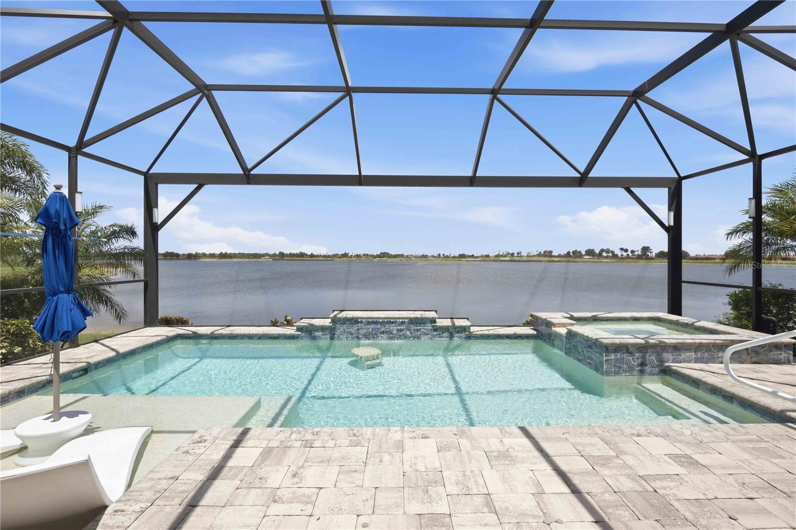 Virtually Staged. Located in the Golf Village of Sarasota National, this Roma Model is a bundled golf home offering 2 bedrooms, 2 bathrooms, a den, and an open floor plan with a custom heated saltwater pool and spa overlooking a long lake view.

Designed for year-round Florida living, the outdoor space features a sun shelf, raised spa, paver lanai, panoramic screen enclosure, and a self-cleaning pool system. Recent updates include a new pool heater and a new salt chlorinator. Storm Smart screens and accordion hurricane shutters provide added protection and peace of mind.

Inside, the kitchen features cabinetry, granite countertops, an oversized island, and an upgraded pantry with custom shelving, all overlooking the main living area with views of the lake. The primary suite offers dual vanities, a walk-in shower with dual shower heads, a private water closet, linen storage, and a custom walk-in closet. The guest bedroom also includes a custom closet, while the den provides flexible space for a home office, hobby room, or additional guest accommodations.

This home includes two deeded golf memberships to Sarasota National Golf Club. The championship golf course is nearing completion of its renovation by the nationally recognized Fry/Straka design team, and the seller has paid the golf assessment in Full, allowing the new owner to enjoy the renovated course without assuming that expense.

Residents enjoy resort-style amenities including a 30,000-square-foot clubhouse, 7,000-square-foot fitness center, resort pool with lap lanes and spa, tennis, pickleball, bocce, coffee lounge, library, day spa, and multiple dining venues including the Palm Dining Room, Palm Lounge, 19th Hole Bar & Grill, and Tiki Bar. The home is located approximately 8.5 miles from Historic Downtown Venice, 7 miles from Manasota Beach, 5 miles from Wellen Park, and less than 7 miles from I-75.