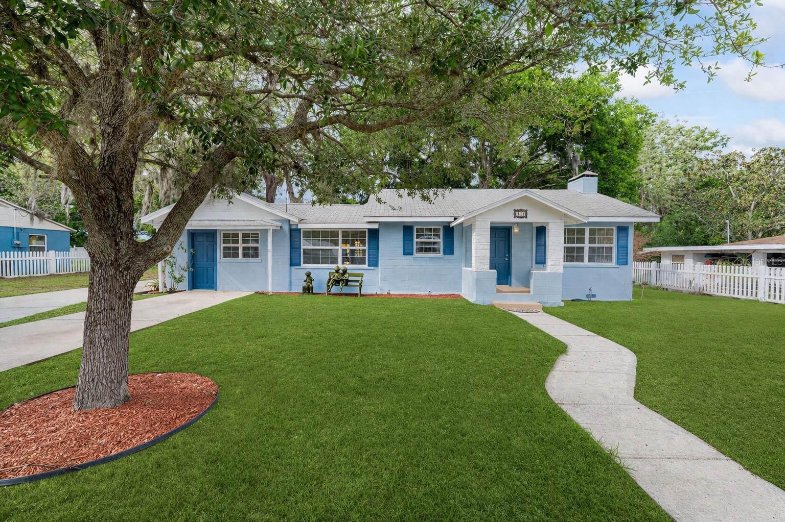 **NEW ROOF 6/7/26** Fresh, inviting, and full of character, this beautifully painted and partially updated 3 bedroom, 3 bathroom block construction home in Eustis, Florida is the kind of property that immediately feels like home the moment you arrive. With a freshly painted interior and a charming picket fence out front, it offers curb appeal and comfort that stands out in today’s market.

Step inside to a spacious, open layout designed for both everyday living and easy entertaining. The main living area is warm and welcoming, centered around a wood burning fireplace that creates a cozy focal point while seamlessly connecting to the kitchen. Whether you are hosting guests or enjoying a quiet night in, this space is designed to feel like home. Unique to this home, a second wood burning fireplace is located in the second bedroom, adding character and flexibility for a guest suite, office, or creative space.

Throughout the home, you will find a thoughtful blend of real hardwood flooring, tile, and luxury vinyl, offering both style and durability. The primary suite provides a private retreat with its own en suite bathroom, while the second bedroom also has its own en suite bathroom that was recently remodeled and the third bedroom is positioned with convenient access to the third bathroom, creating comfort and privacy for family or guests.

The kitchen comes fully equipped with all appliances included, making this home truly move in ready. Every detail has been designed with functionality in mind so you can settle in without the extra work.

Step outside and discover a large, shaded backyard that offers endless possibilities. Whether you envision relaxing evenings around a fire pit, weekend gatherings with friends, or simply enjoying the Florida weather, this outdoor space delivers. Additional storage sheds provide practical space for tools, hobbies, or extra storage, and a generator hookup at the rear electrical panel adds an extra layer of preparedness and peace of mind.

Location is another standout feature. Situated near Lake Eustis, Lake Woodward, and West Crooked Lake, you are just minutes from boating, fishing, and enjoying the natural beauty that makes Central Florida so desirable. With convenient access to major highways, shopping, dining, and everyday essentials, this home offers the perfect balance of tranquility and accessibility.

If you have been looking for a home that combines space, charm, and a prime Eustis location, this one checks all the boxes.

Schedule your private showing today and come experience it for yourself.
