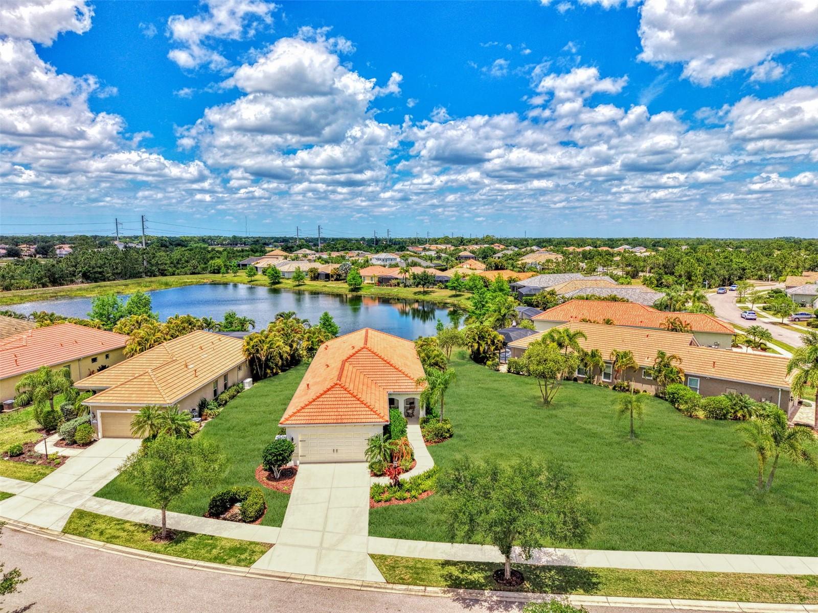 NEW PRICE on this beautifully upgraded home in the highly sought-after community of Grand Palm! Situated on an oversized pie-shaped waterfront lot with expansive open space and peaceful pond views, this meticulously maintained home offers the perfect blend of comfort, style, and functionality.

Offering 3 bedrooms, 2 bathrooms, a flex space, dedicated office, and a 2-car garage, this thoughtfully designed split floor plan provides privacy with the guest bedrooms tucked away from the spacious primary suite. From the moment you arrive, you'll appreciate the oversized covered front porch with sitting area, upgraded landscaping, freshly repainted exterior, extended driveway, and charming glass front entry door.

Inside, the home feels light, bright, and inviting with newly installed porcelain plank tile flooring throughout all main living areas and bedrooms (offering a completely carpet-free interior) along with recessed lighting, stunning fixtures and ceiling fans, and a tray ceiling accenting the great room.The open-concept kitchen features bright cabinets, tile backsplash, and overlooks the spacious living and dining areas, perfect for everyday living and/or entertaining.

The primary suite offers private access to the extended screened lanai through a glass door, a large walk-in closet, and an ensuite bath with double sinks and generous storage. Additional highlights include a spacious office with glass double doors, generous hallway and guest bath storage, new impact windows and sliding glass door throughout, gutters surrounding the home, and a massive side yard rarely found in the community.

Enjoy Florida living year-round from the extended screened lanai overlooking tranquil water views, all while being located within Grand Palm, one of Venice’s most amenity-rich communities featuring resort-style pools, fitness center, pickleball, tennis, walking trails, kayak launch, dog parks, and more.  All of this is just minutes from beaches, shopping, dining, and major roadways. Schedule your private showing today.